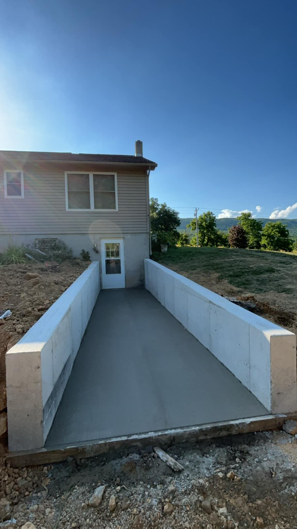 There is a ramp leading to the door of a house.