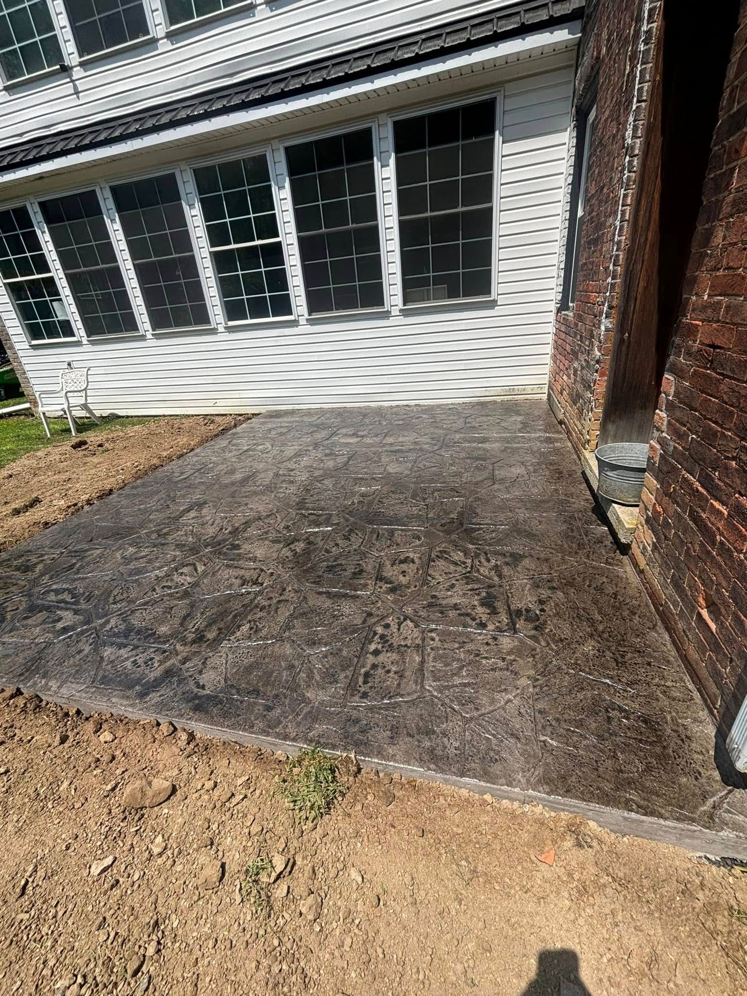 A concrete walkway is being built in front of a house.