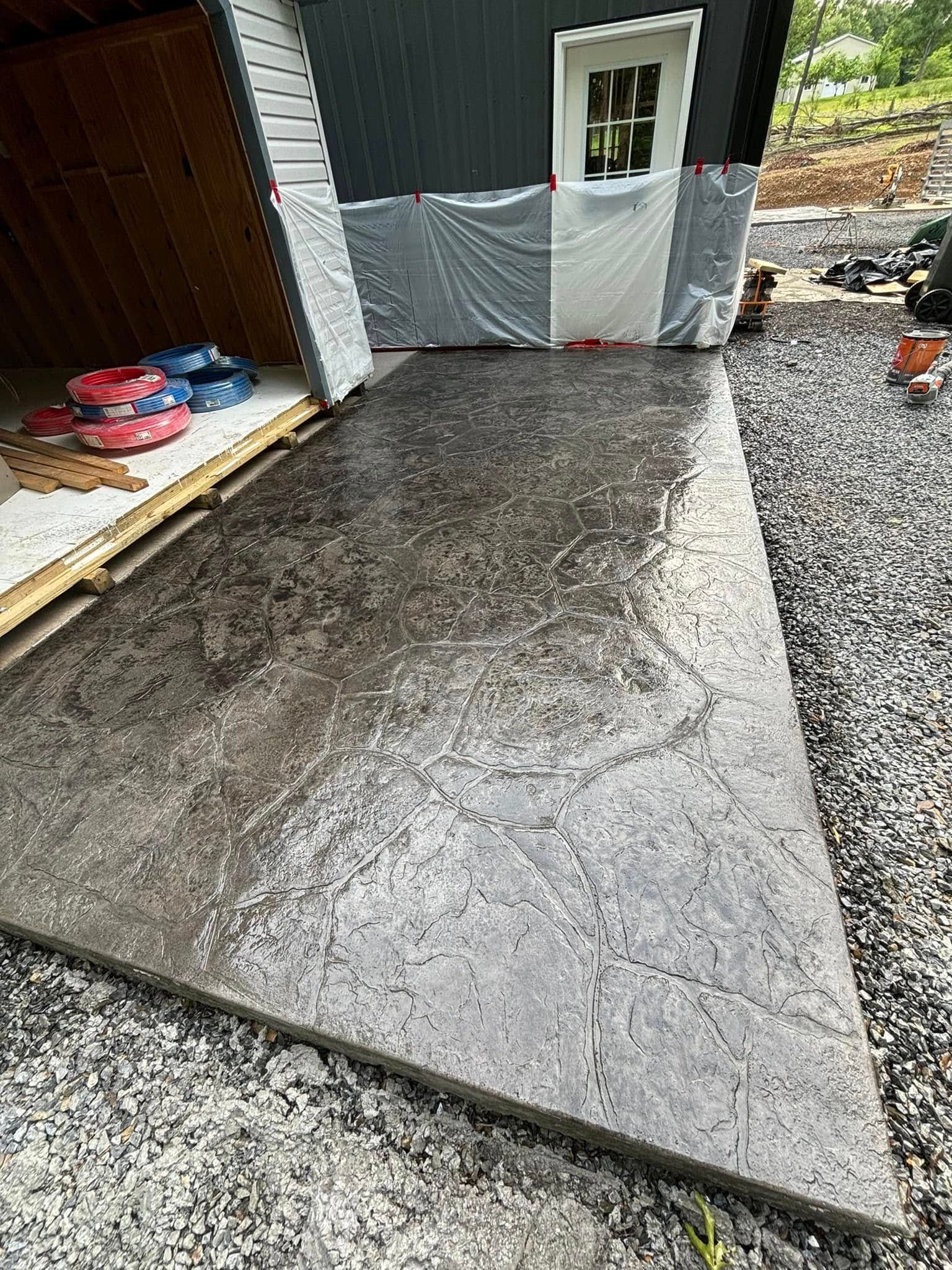 A large concrete slab is sitting in front of a shed.