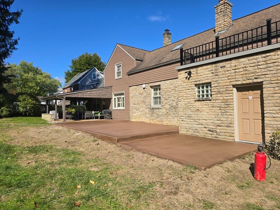 A large brick house with a patio in front of it.