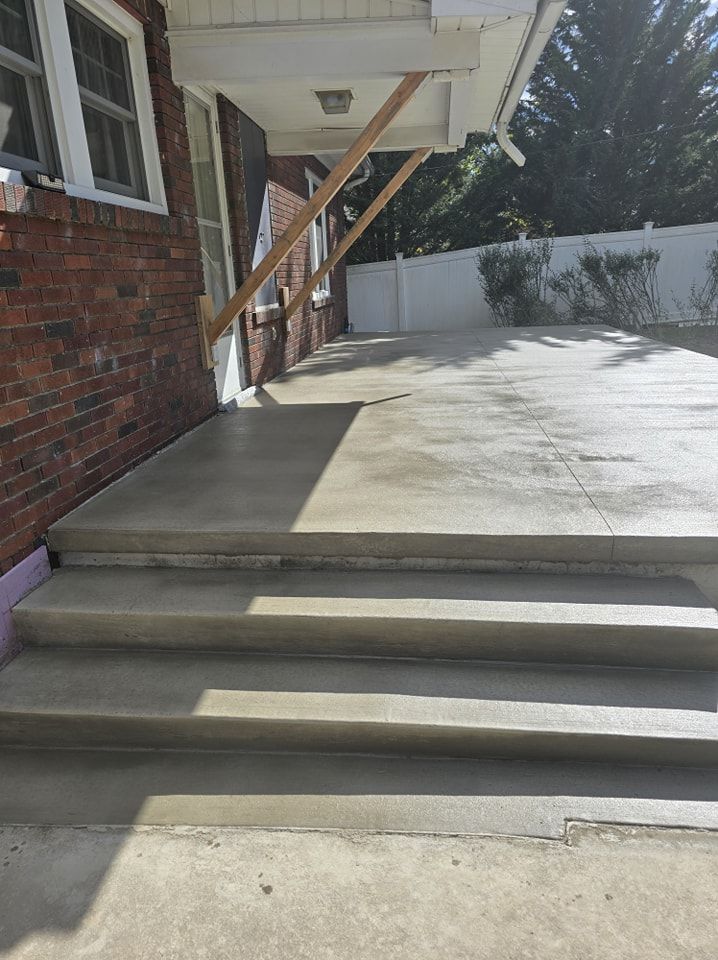 A brick building with concrete steps leading up to it.