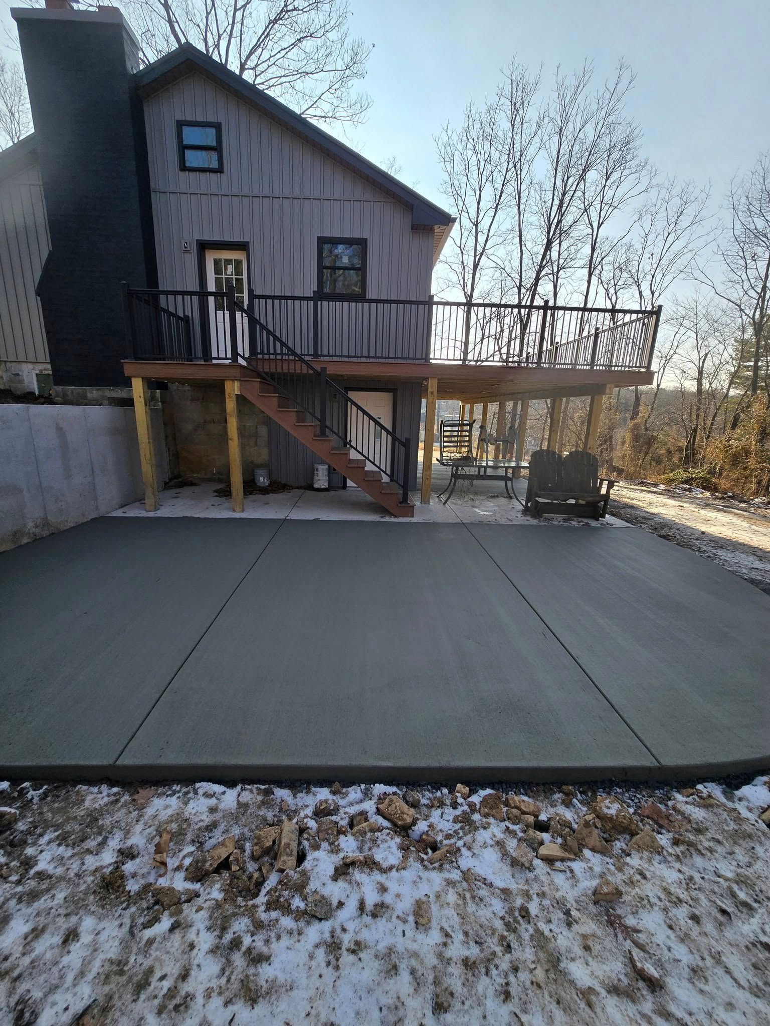 A house with a concrete driveway in front of it.
