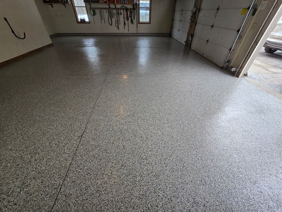 A garage with a shiny floor and a garage door.