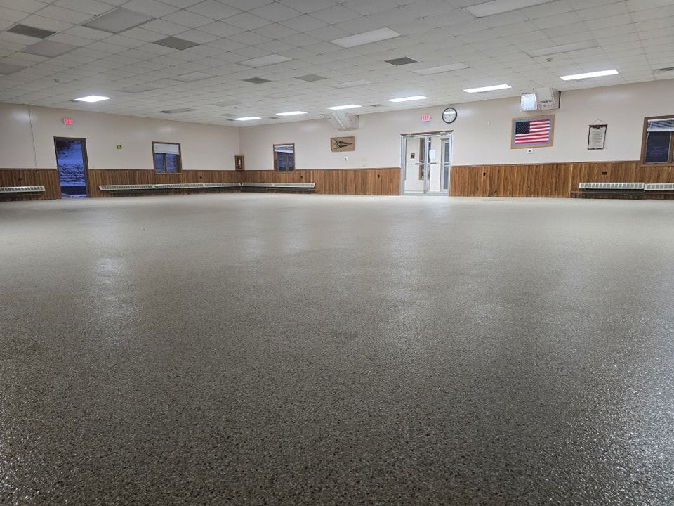 A large empty room with a clock on the wall.