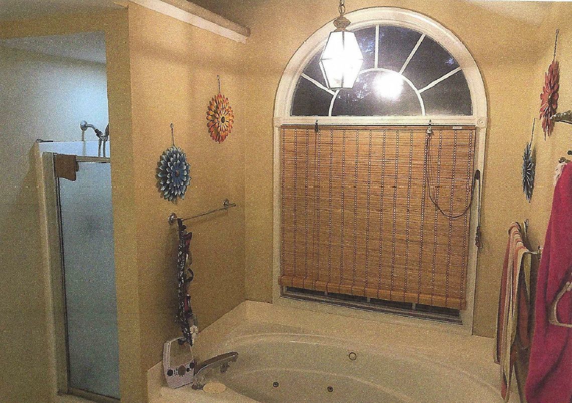 A bathroom with a jacuzzi tub and a window