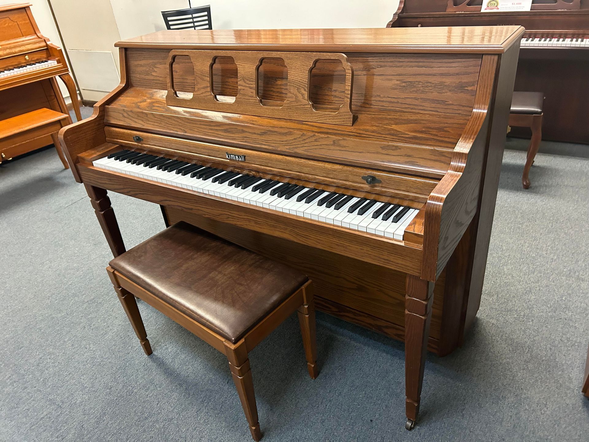 A piano with a bench next to it in a room.