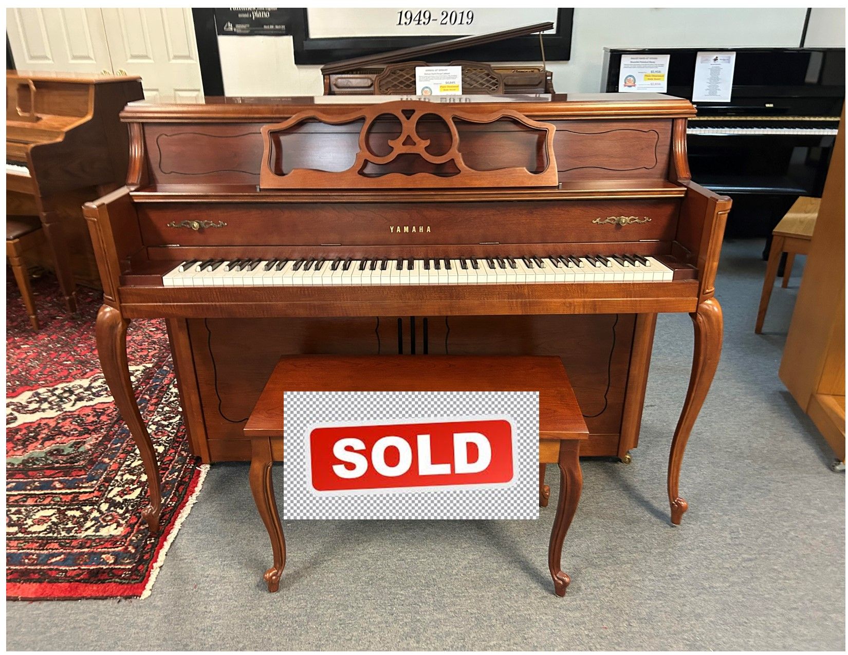 Brown Yamaha upright piano with bench;
