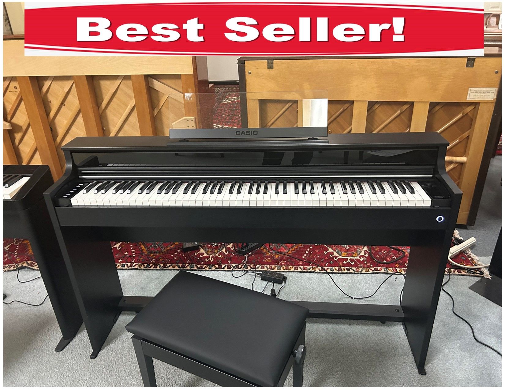 A black piano with a bench next to it in a room.