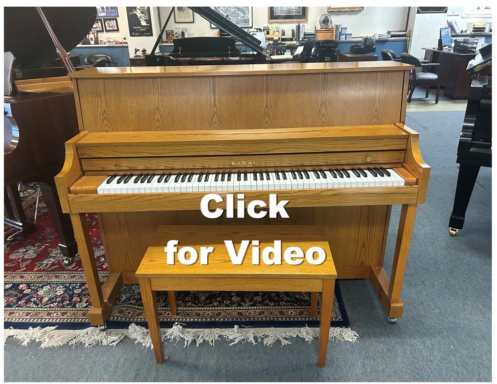 Upright piano with wooden finish and matching bench, indoors.