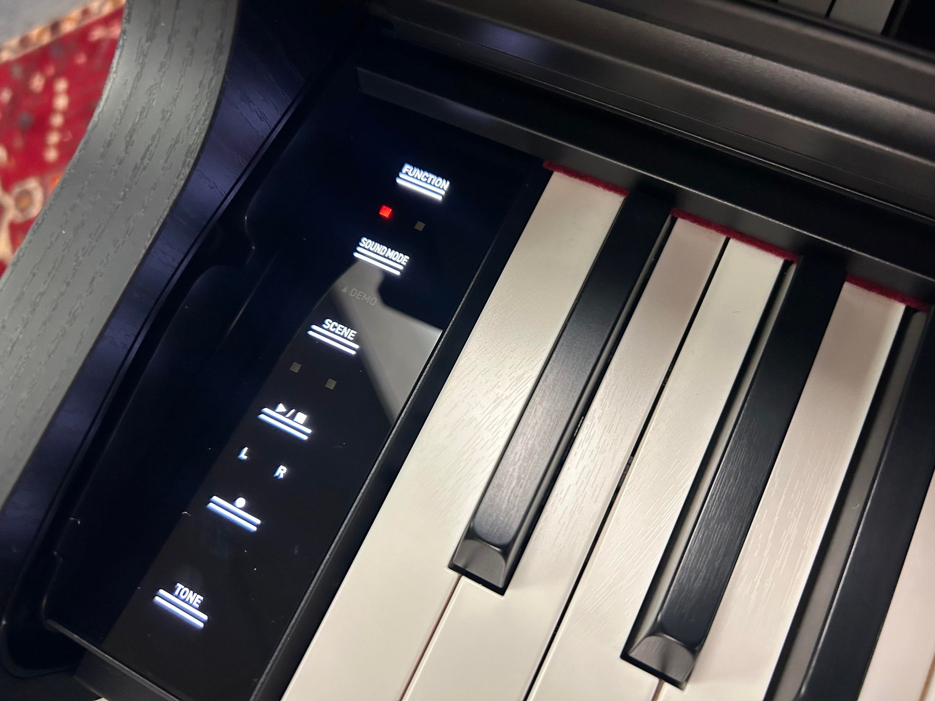 A close up of a piano keyboard with a digital display