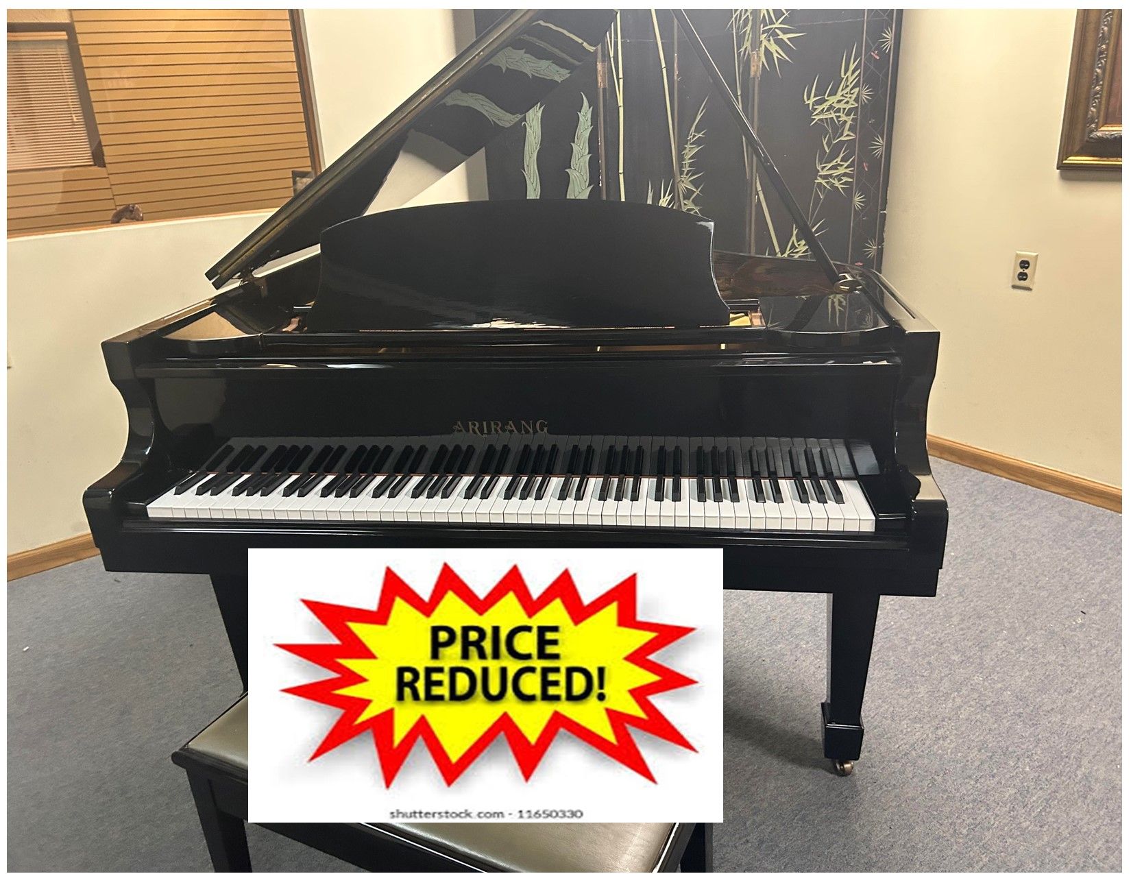 Grand piano with open lid and stool in a room. Click for Video text overlay.