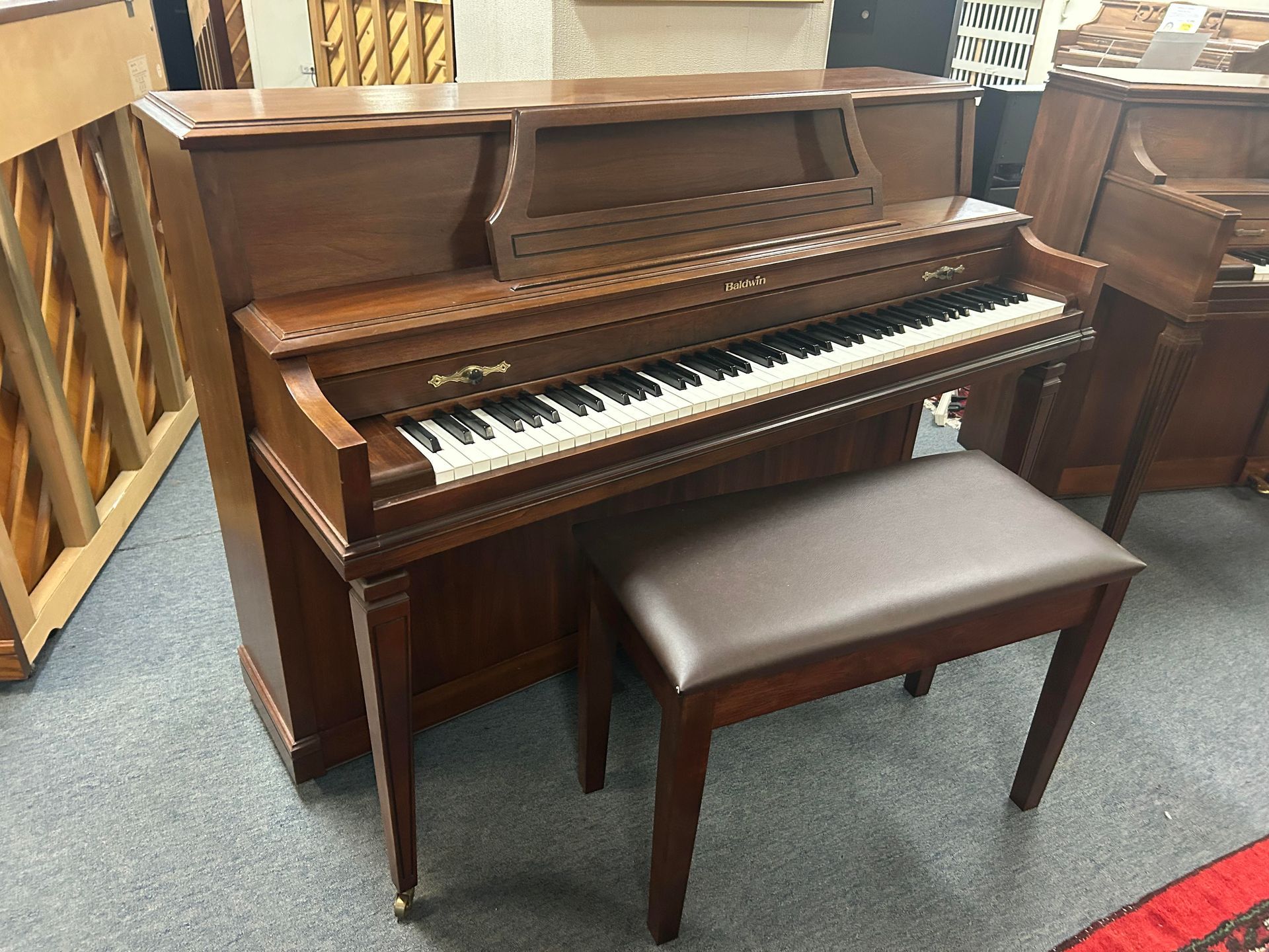 A piano with a bench next to it in a room.