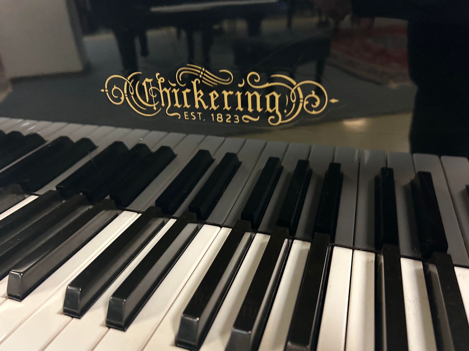 Chickering piano keyboard with logo, black and white keys, est. 1823.