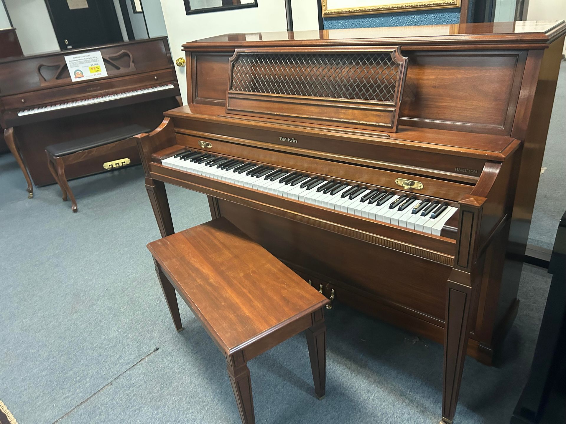 A piano with a bench next to it in a room