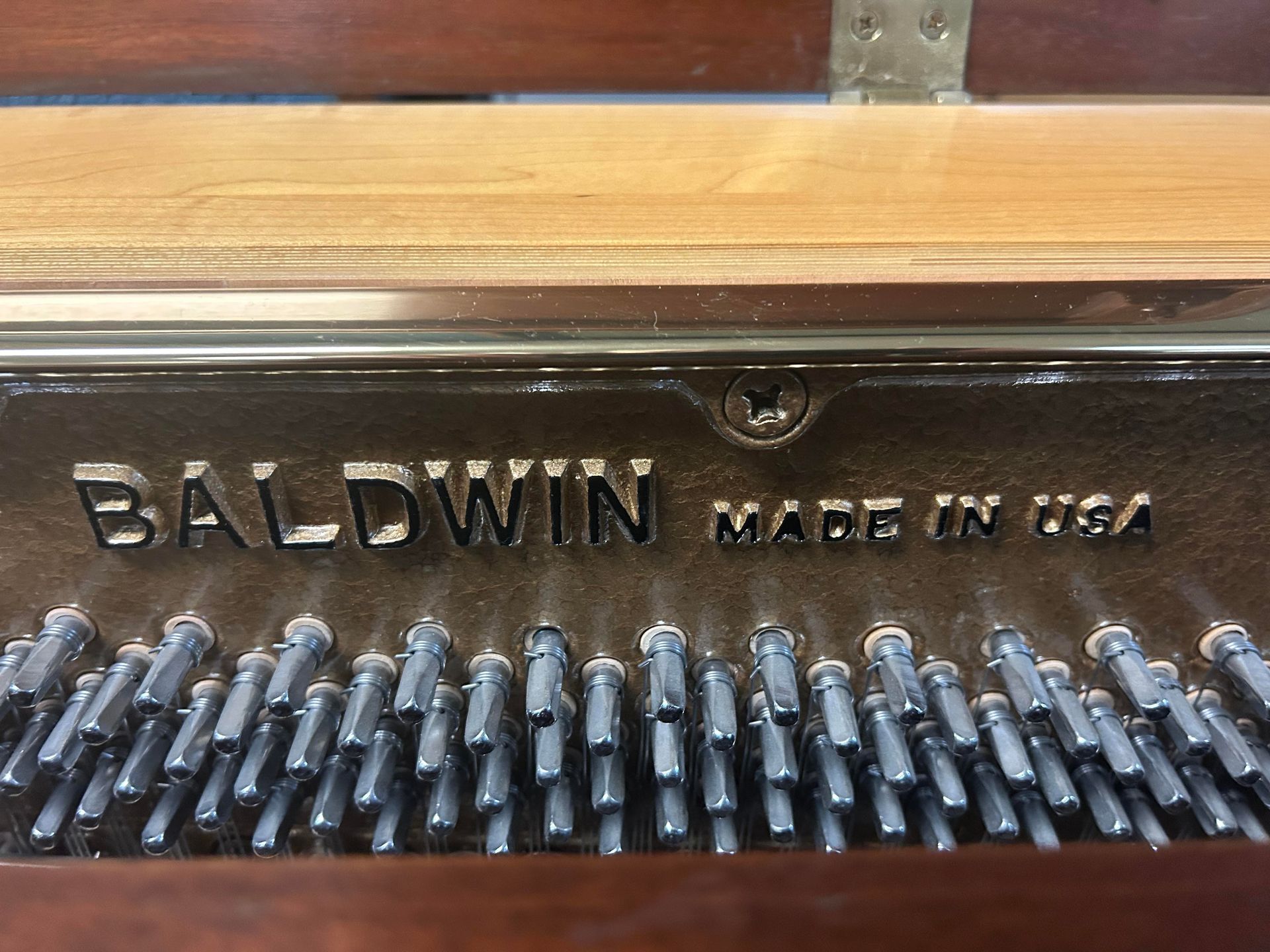 A baldwin piano made in the usa is sitting on a table.