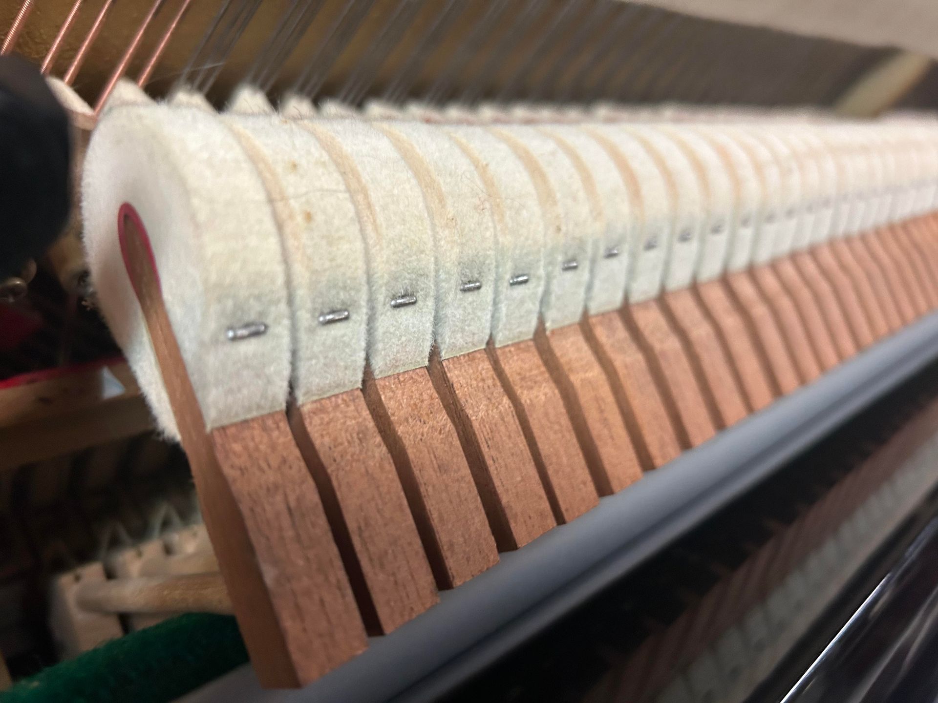 A close up of the inside of a piano keyboard