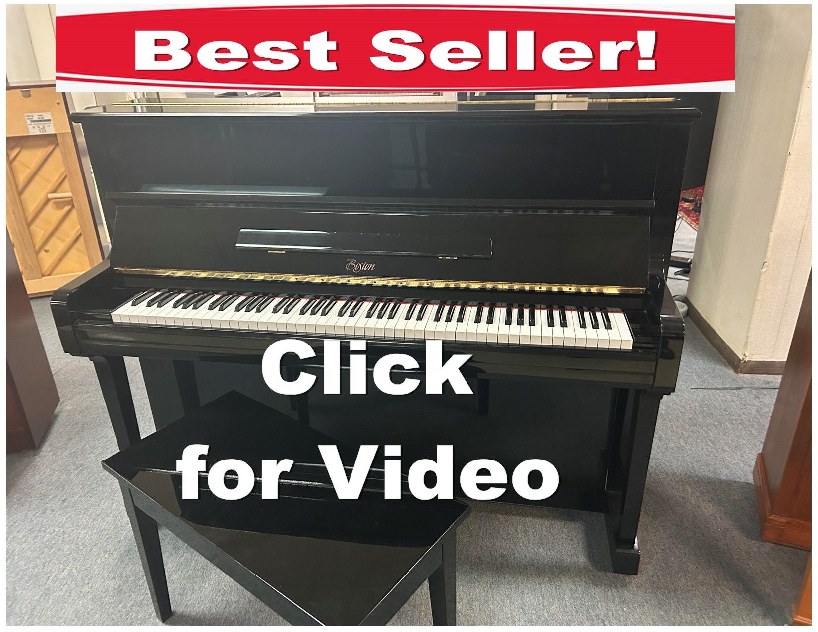 A black upright piano with a stool underneath it.