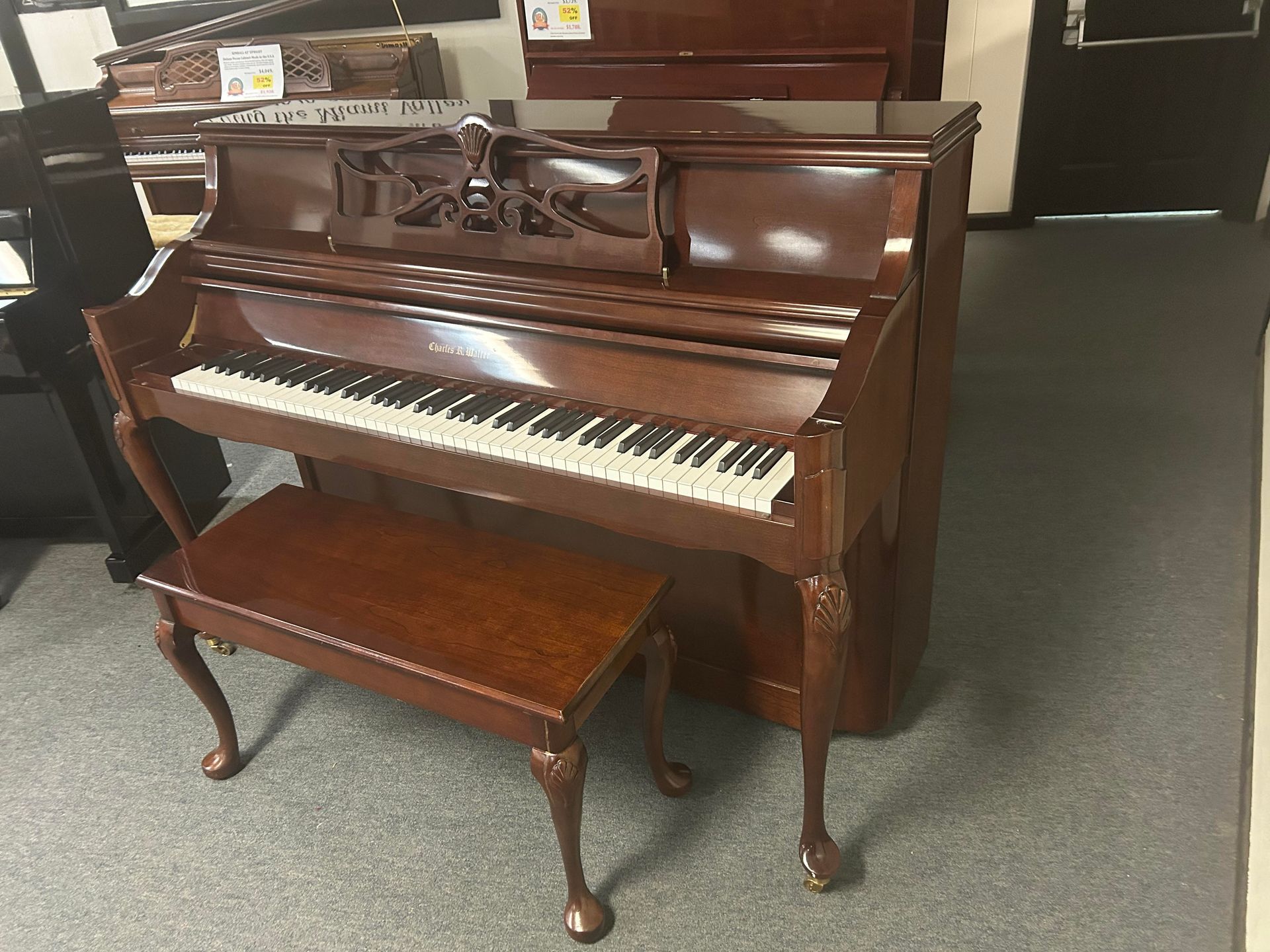 A piano with a bench next to it in a room.