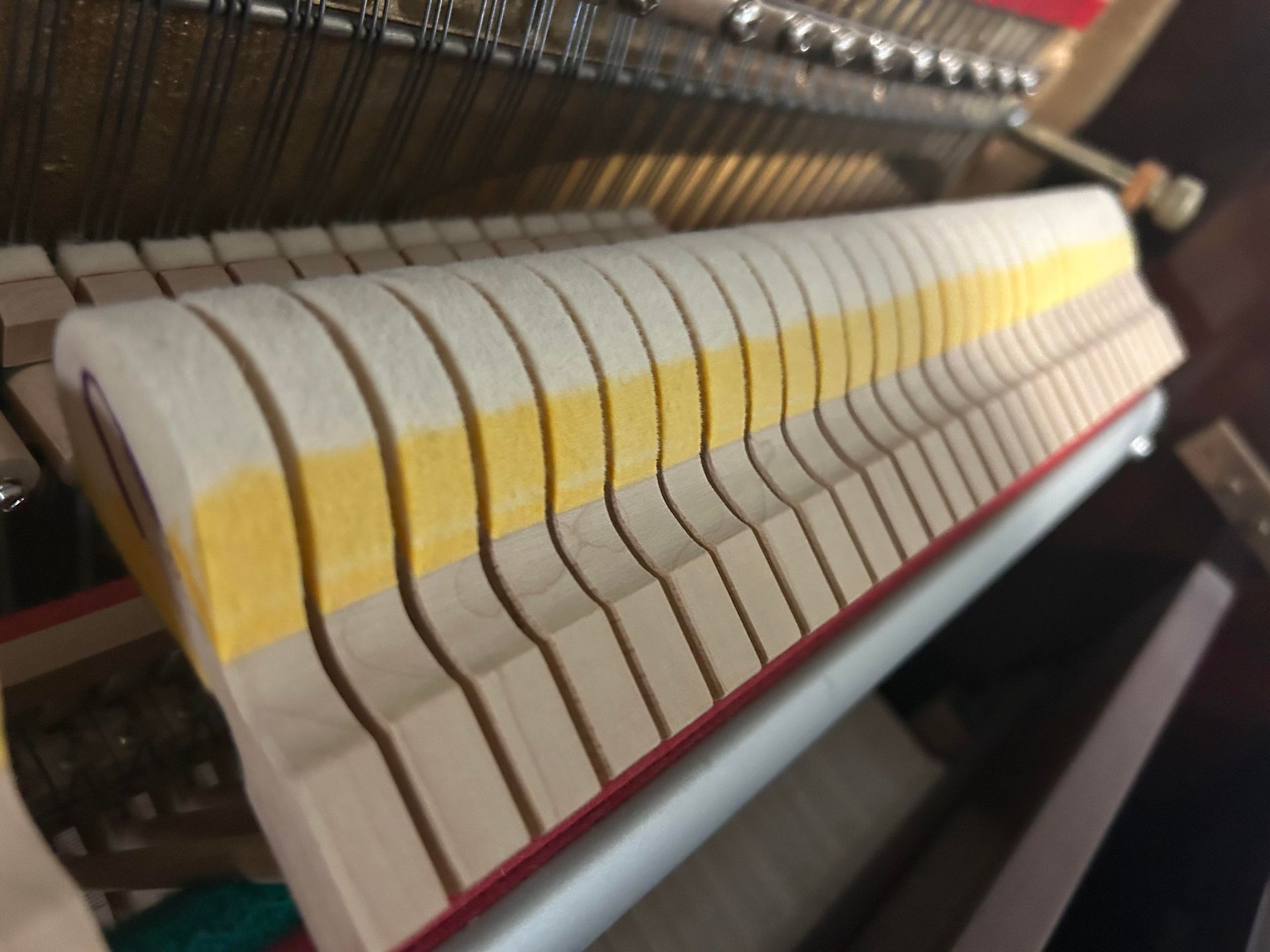 A close up of the inside of a piano keyboard