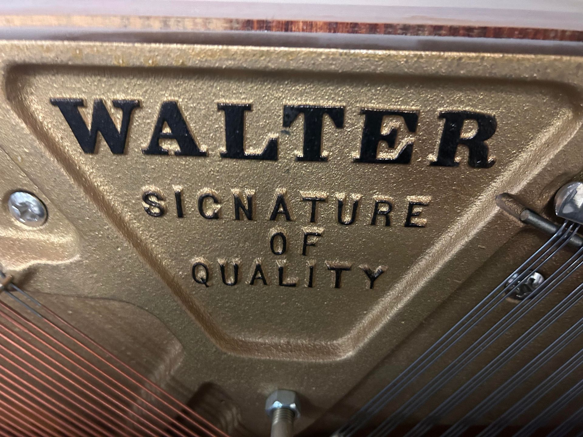 A close up of a walter signature of quality piano