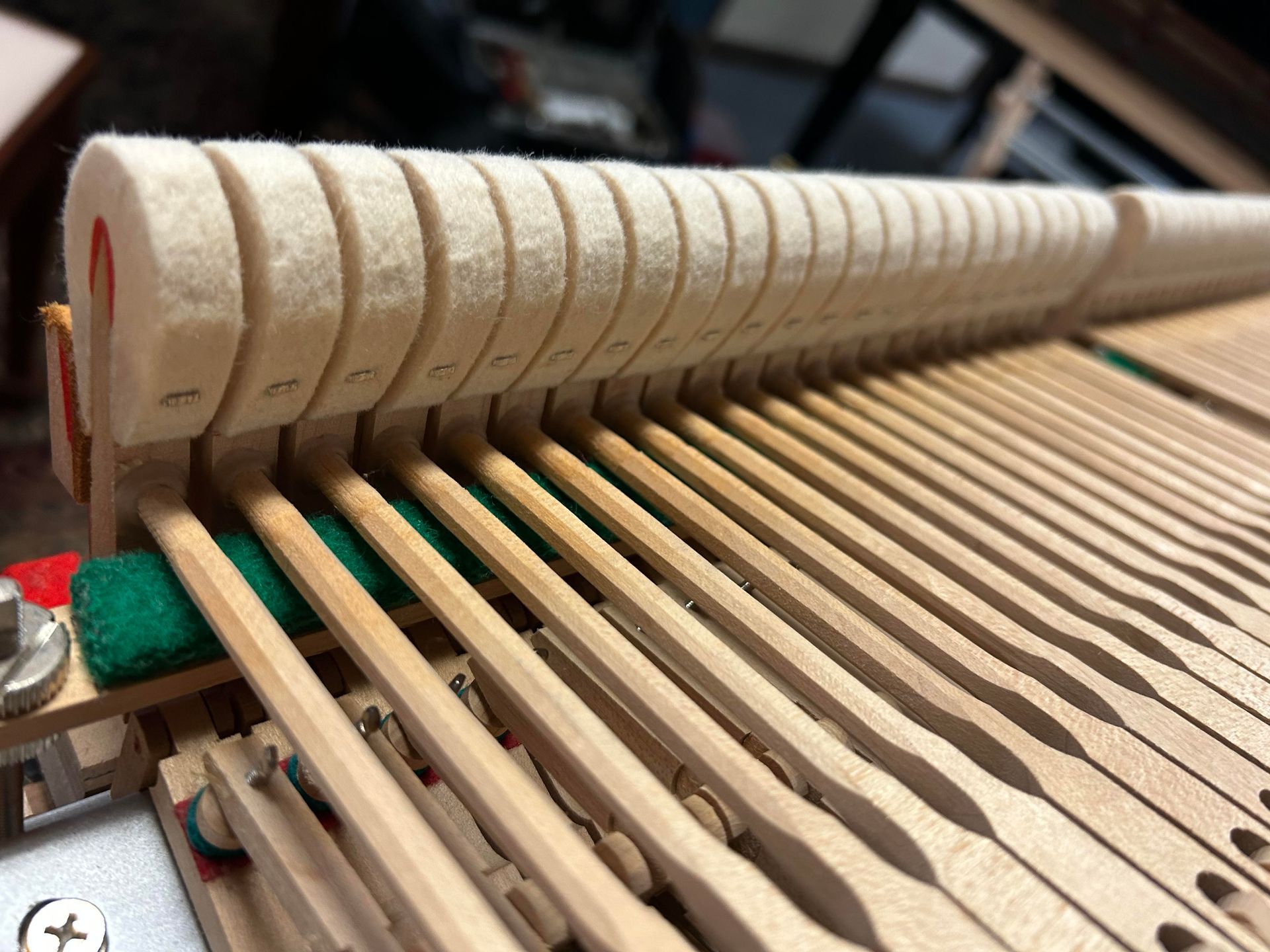 A close up of the inside of a piano.