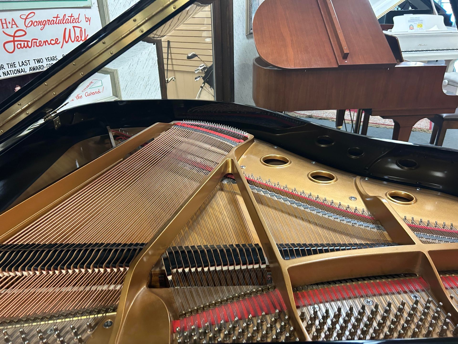 A close up of the inside of a piano with the lid open.