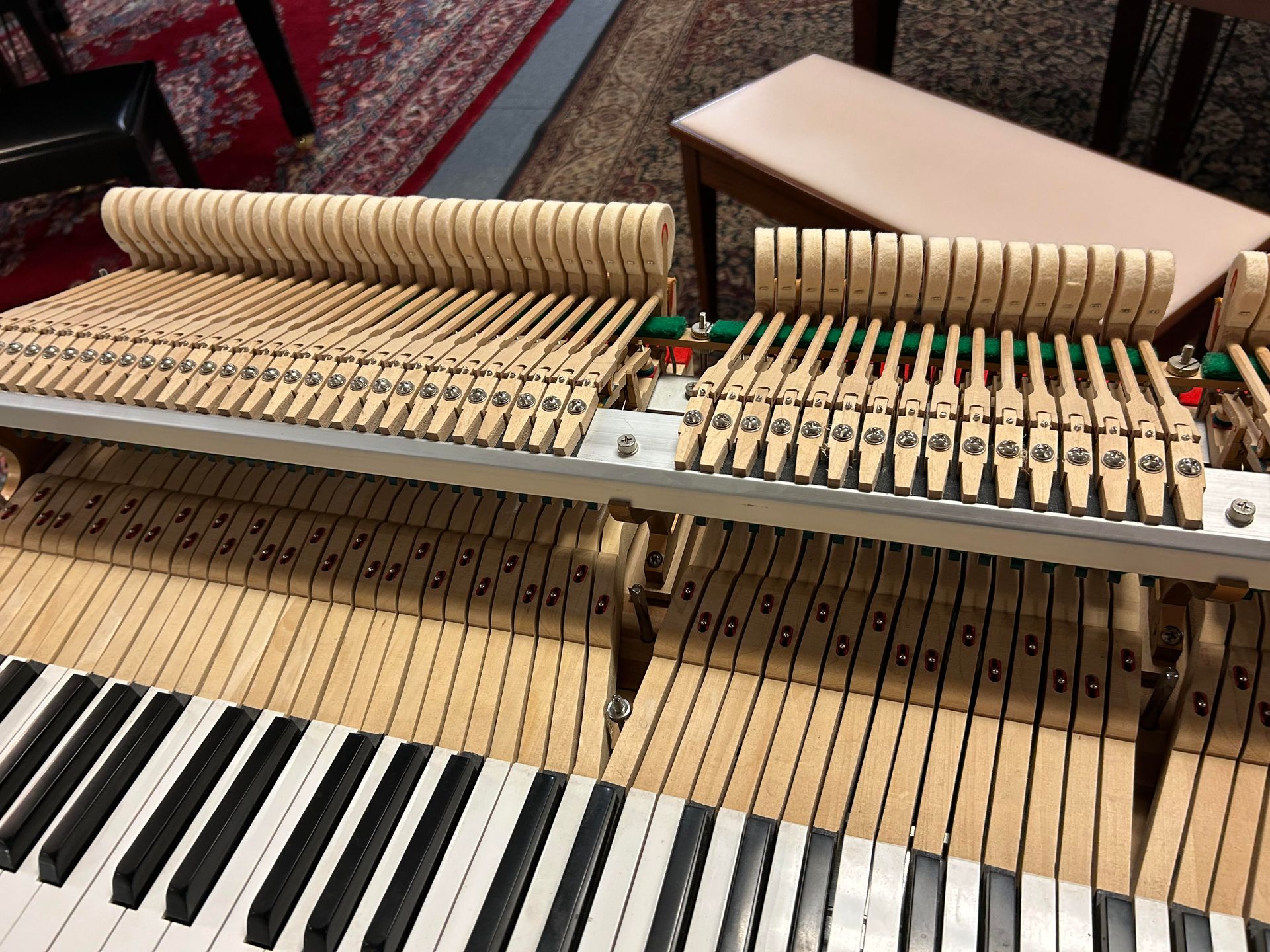 A close up of the inside of a piano keyboard