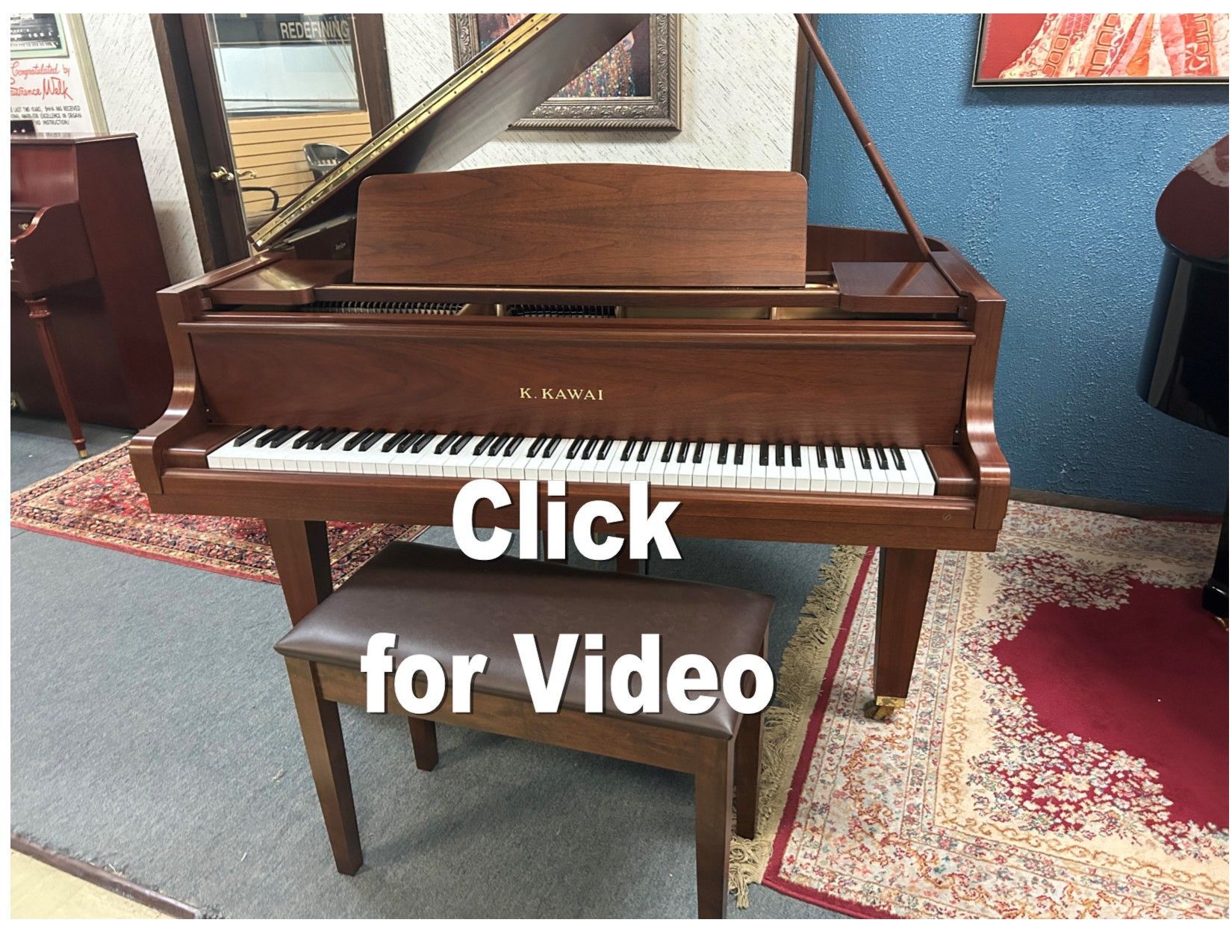 A piano with the words click for video below it
