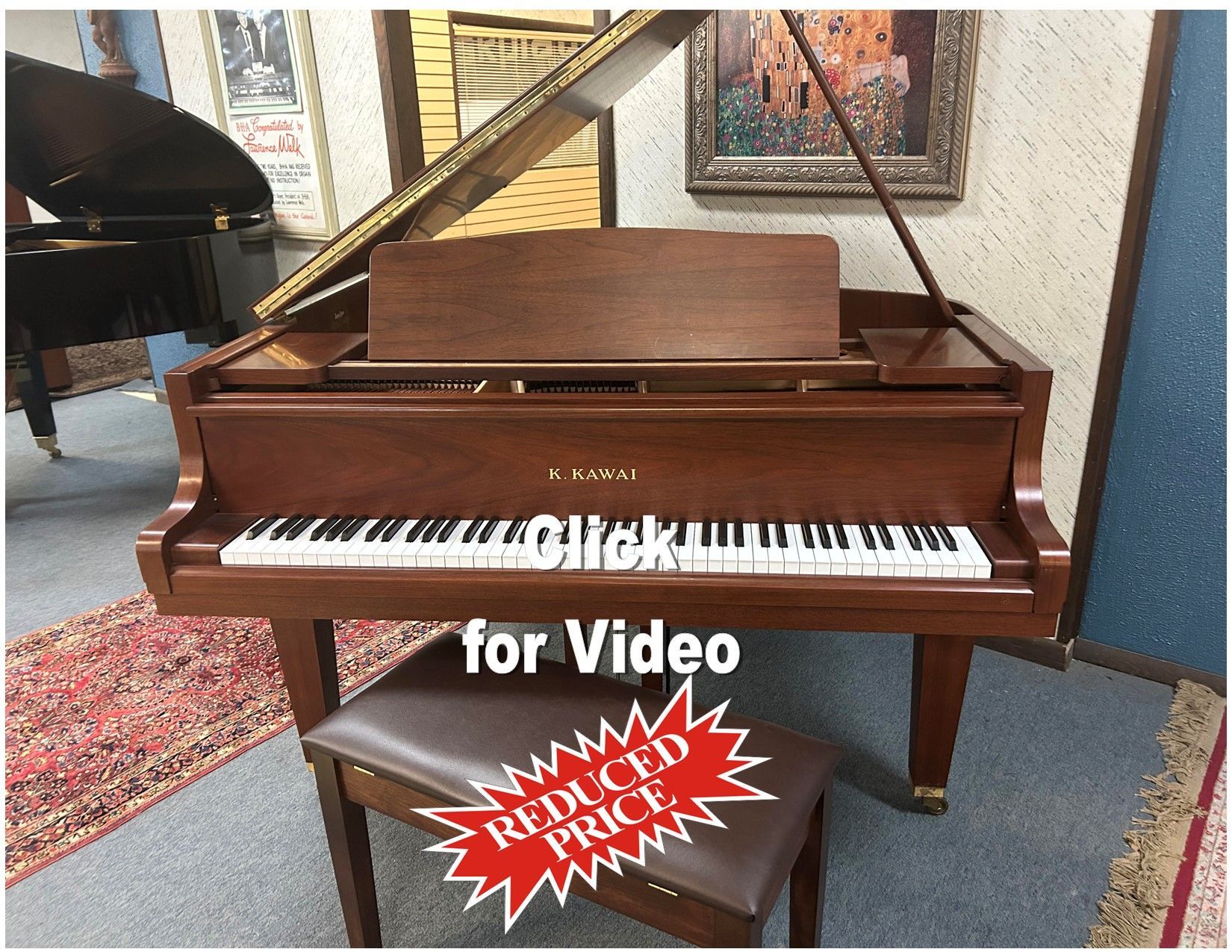 A piano with the words click for video below it
