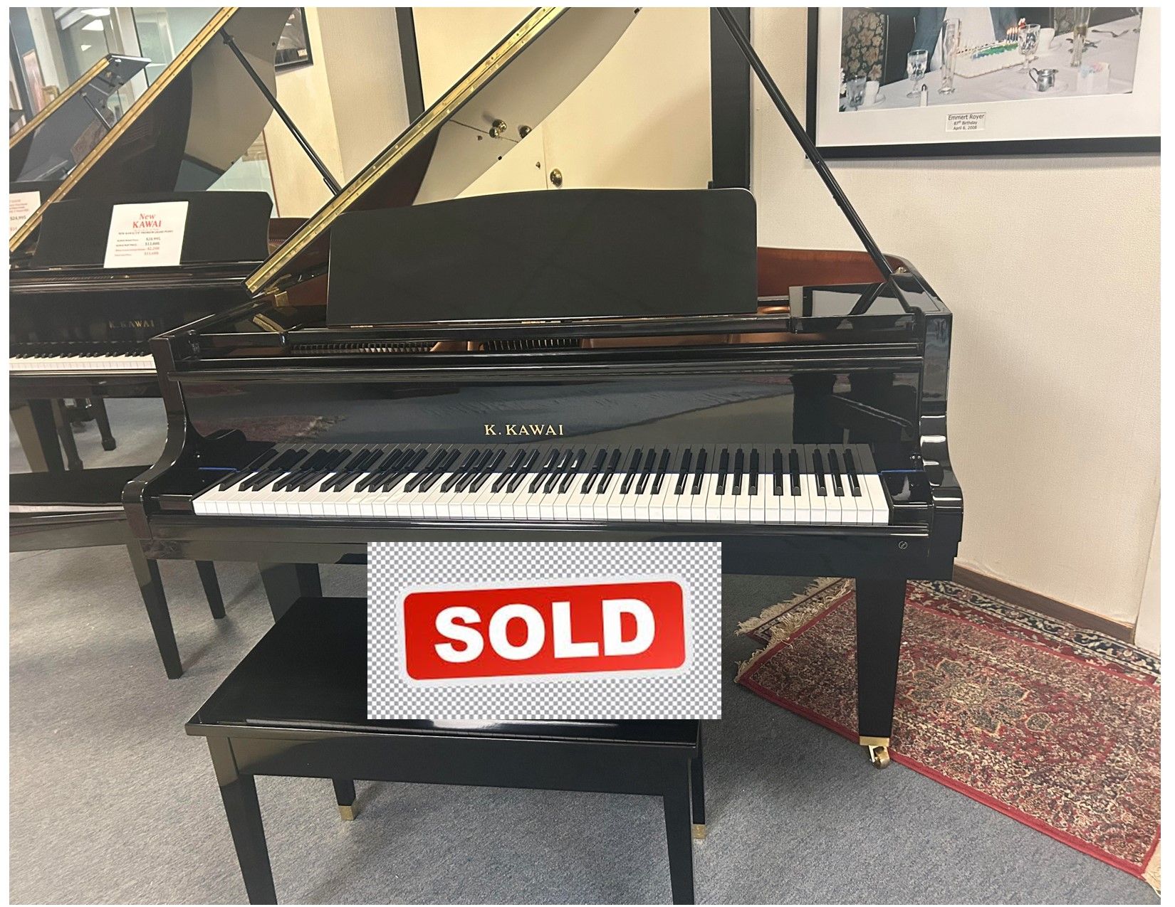 Black Kawai grand piano with bench;