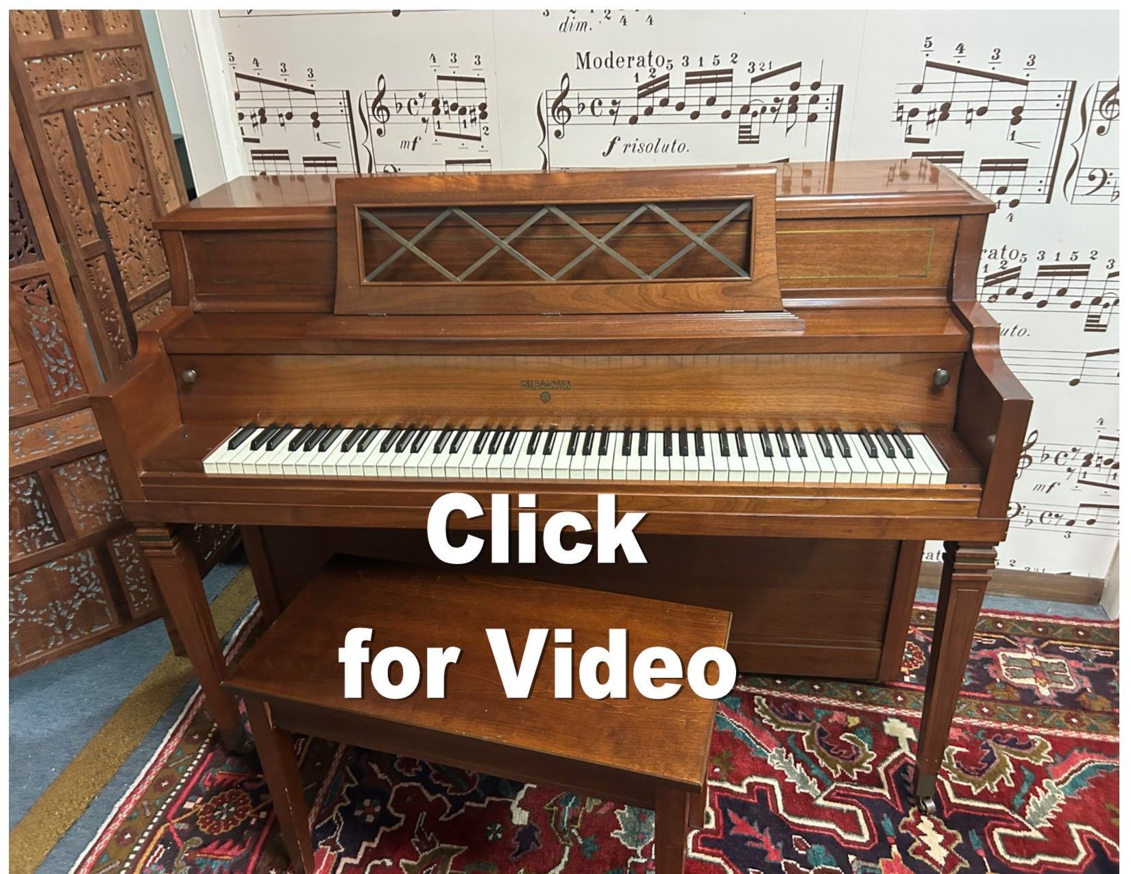 A piano with the words click for video below it