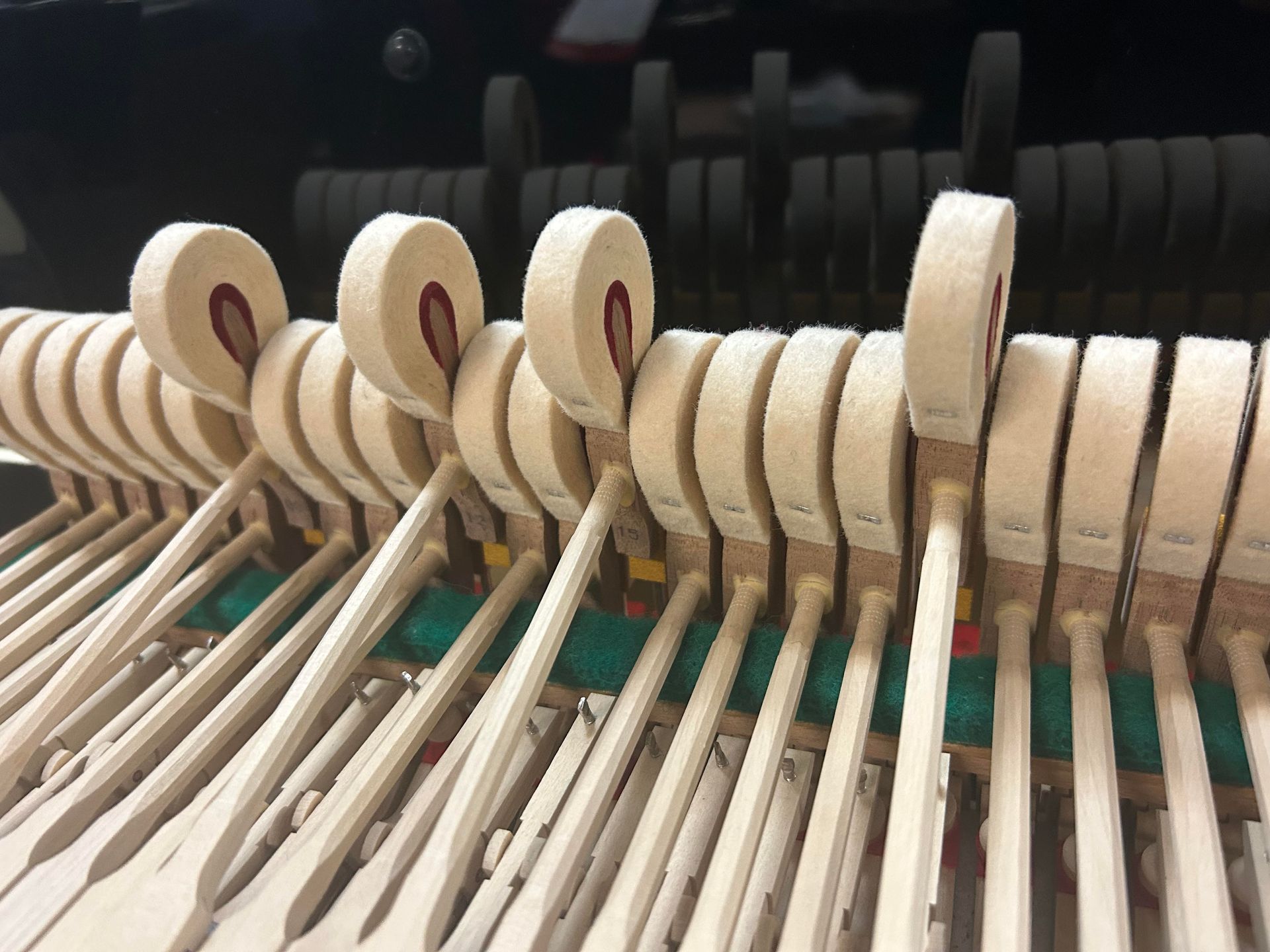 A close up of the inside of a piano keyboard