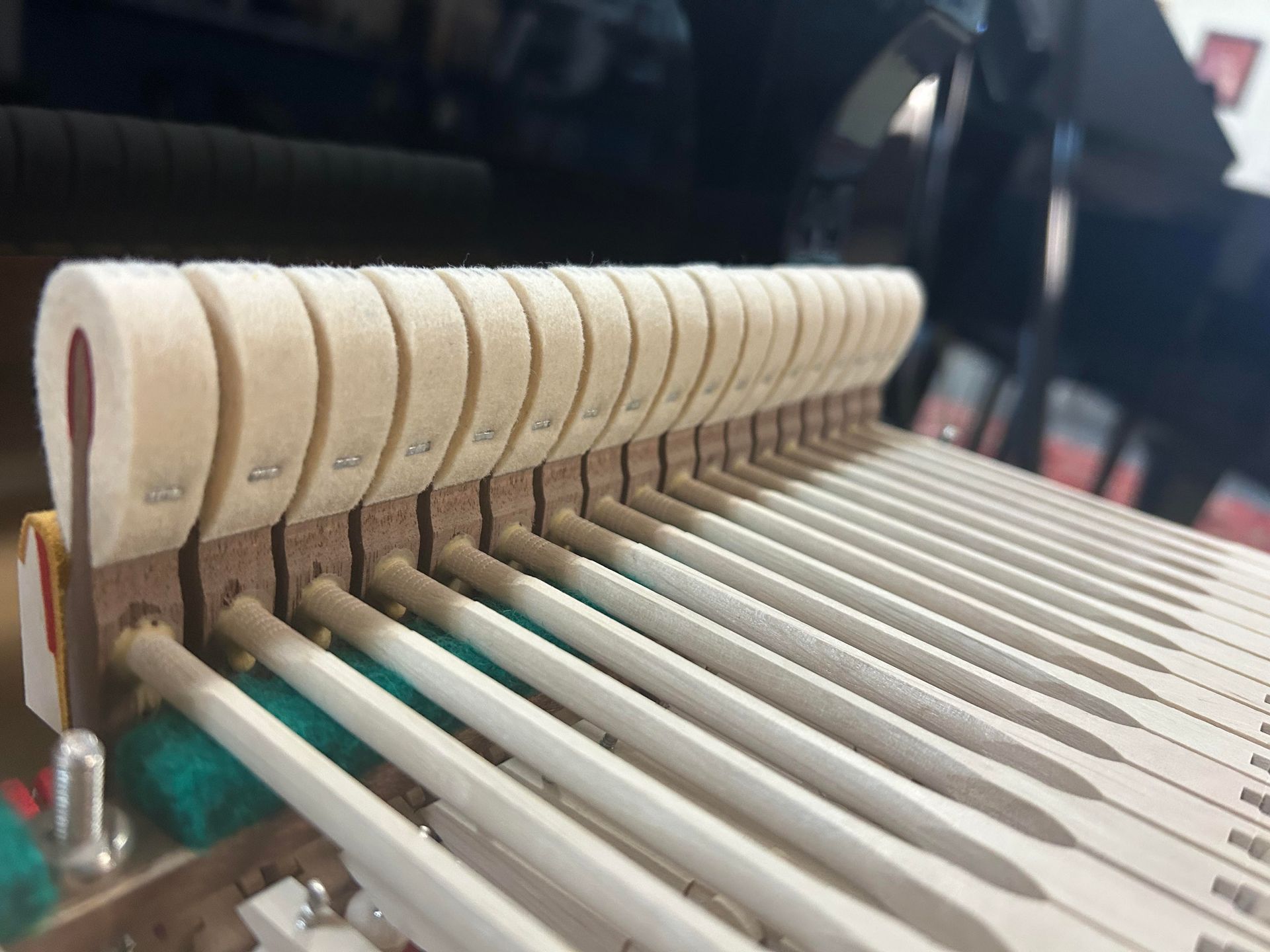 A close up of the inside of a piano keyboard.