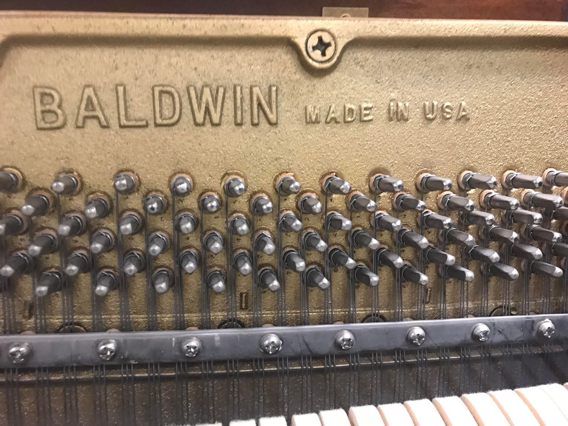 The inside of a baldwin piano made in the usa