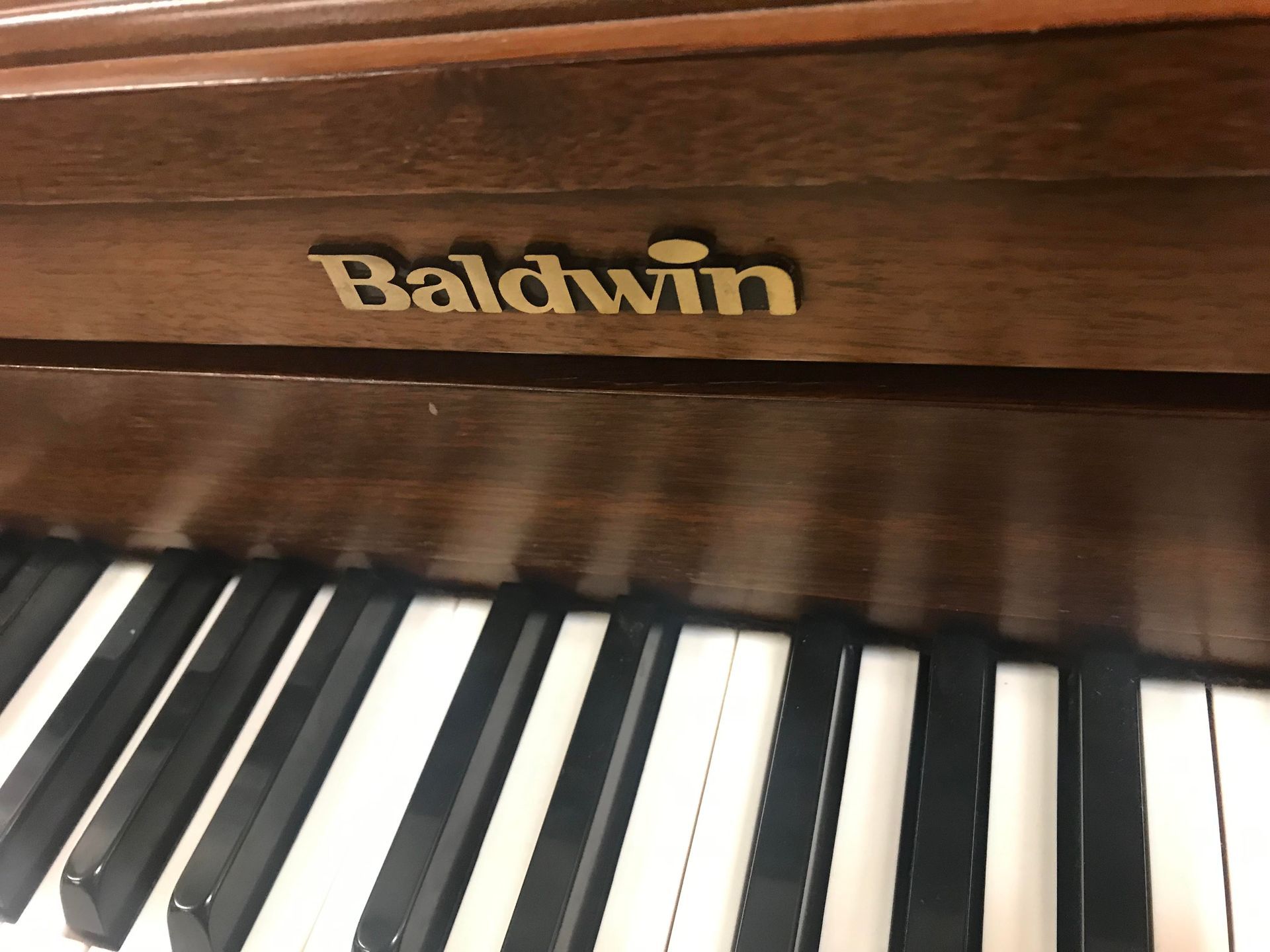 A baldwin piano is sitting on a table