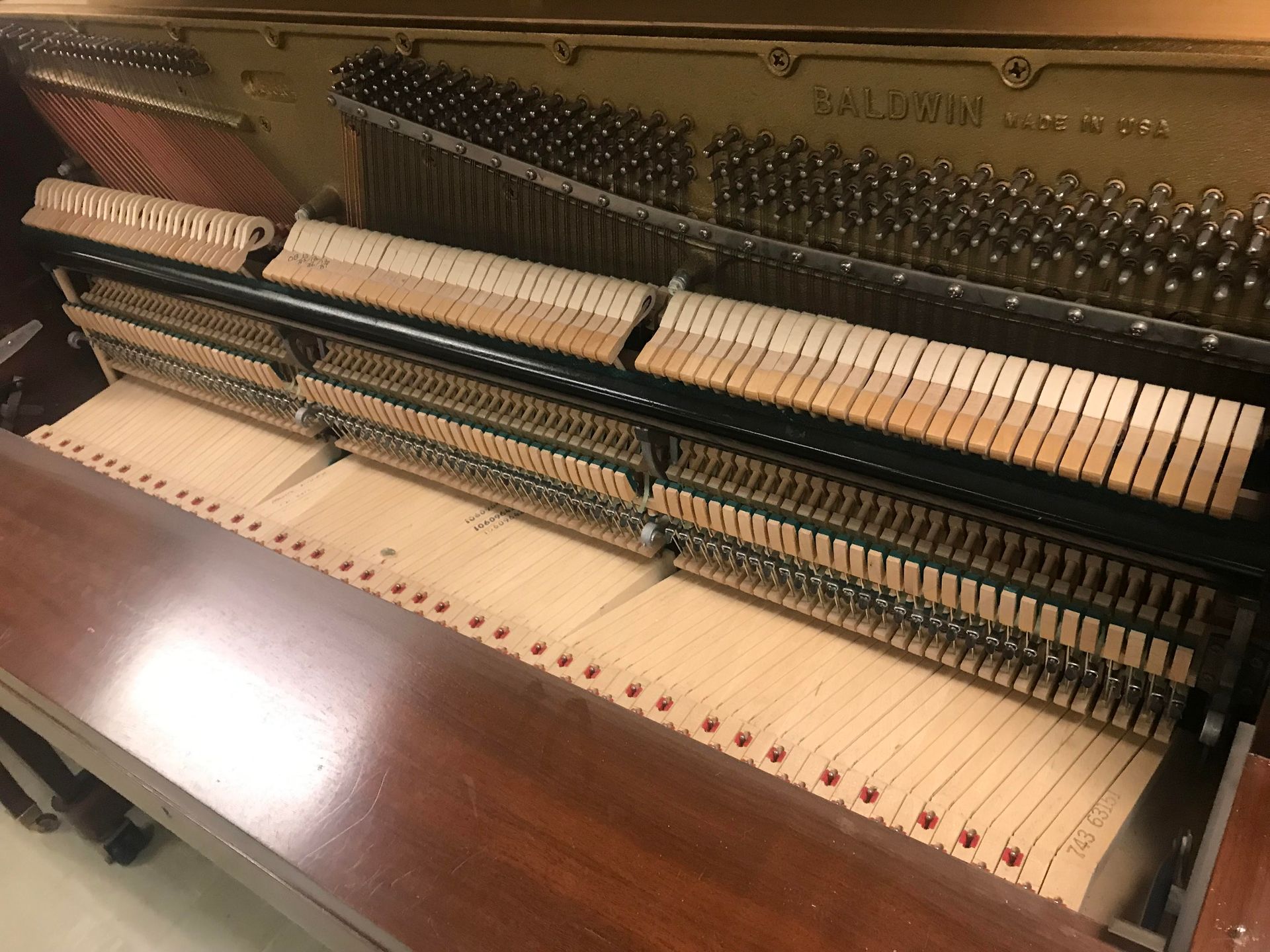 The inside of a piano with the keys visible.