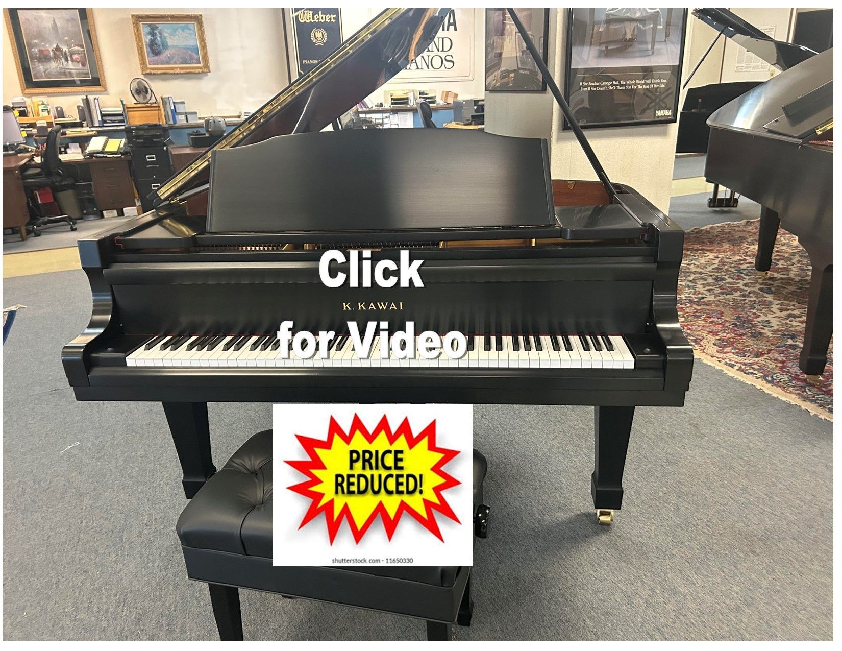 Black grand piano with black leather bench in a showroom, “Video Coming Soon” overlaid.