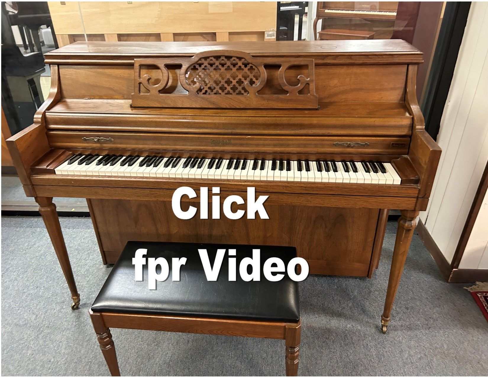 A piano with the words click fpr video below it