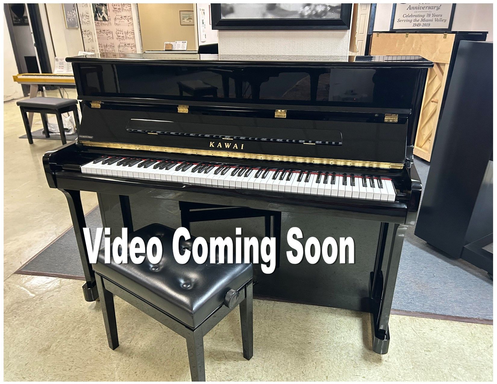 Black Kawai upright piano with bench; 