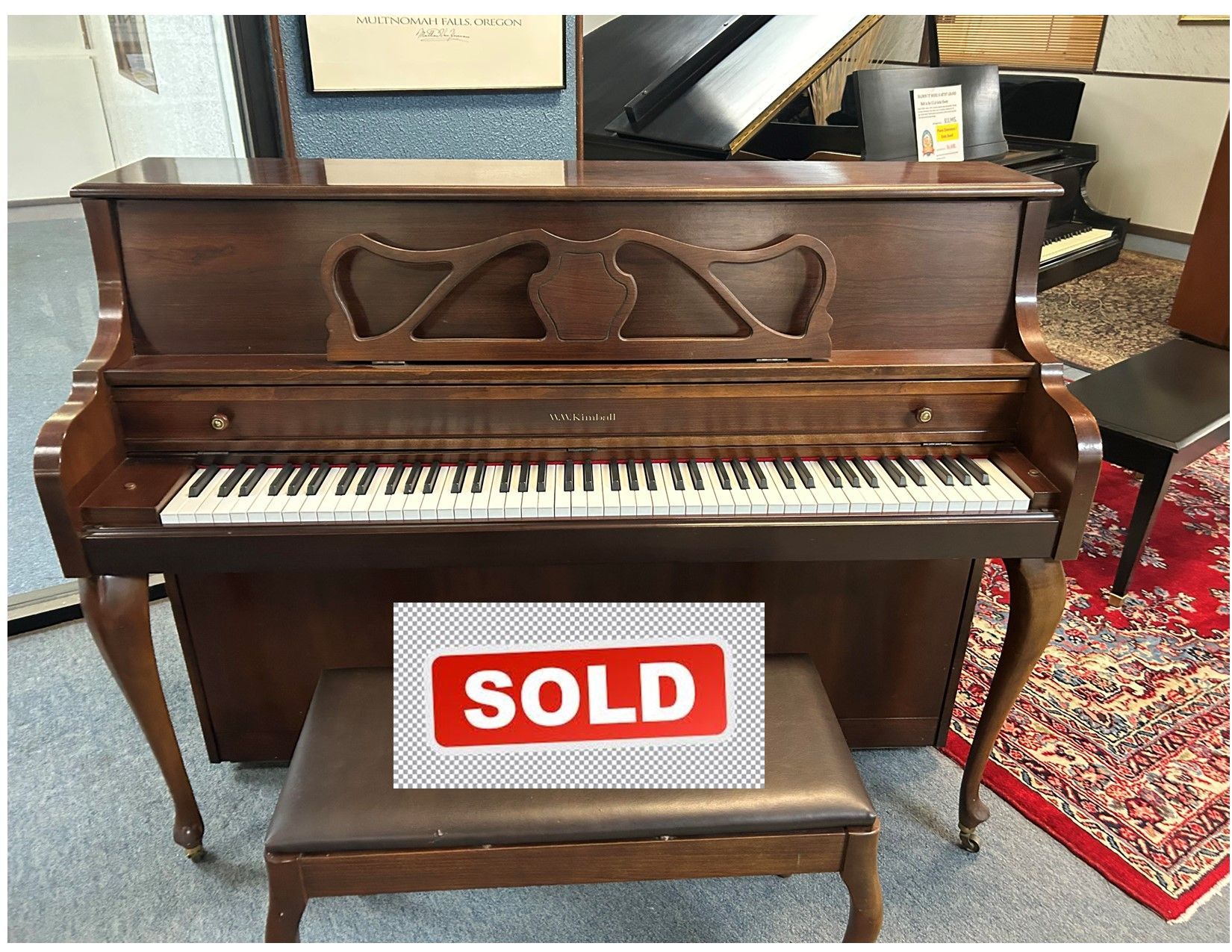 A piano with the words click for video below it