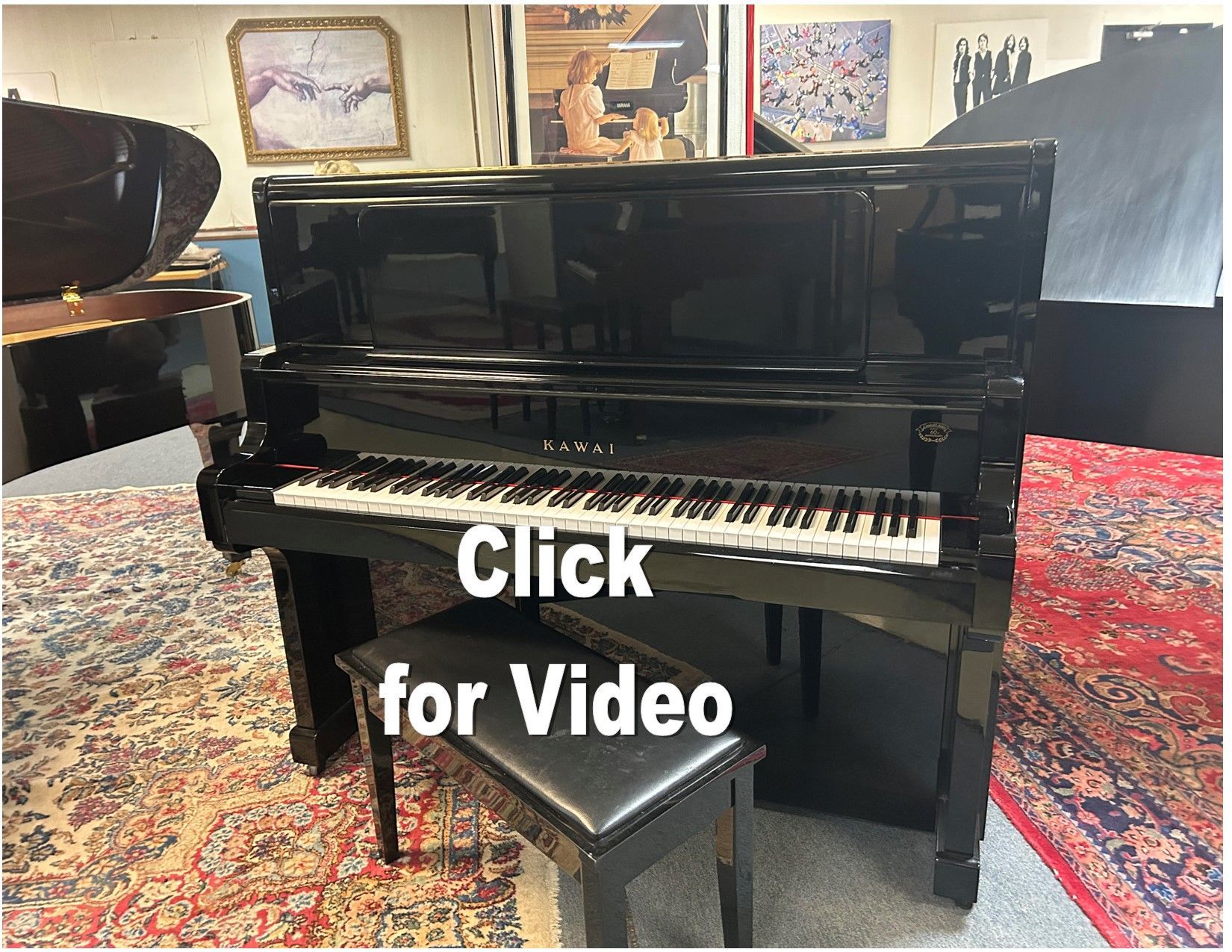 Black Yamaha upright piano with a piano bench on a patterned rug.