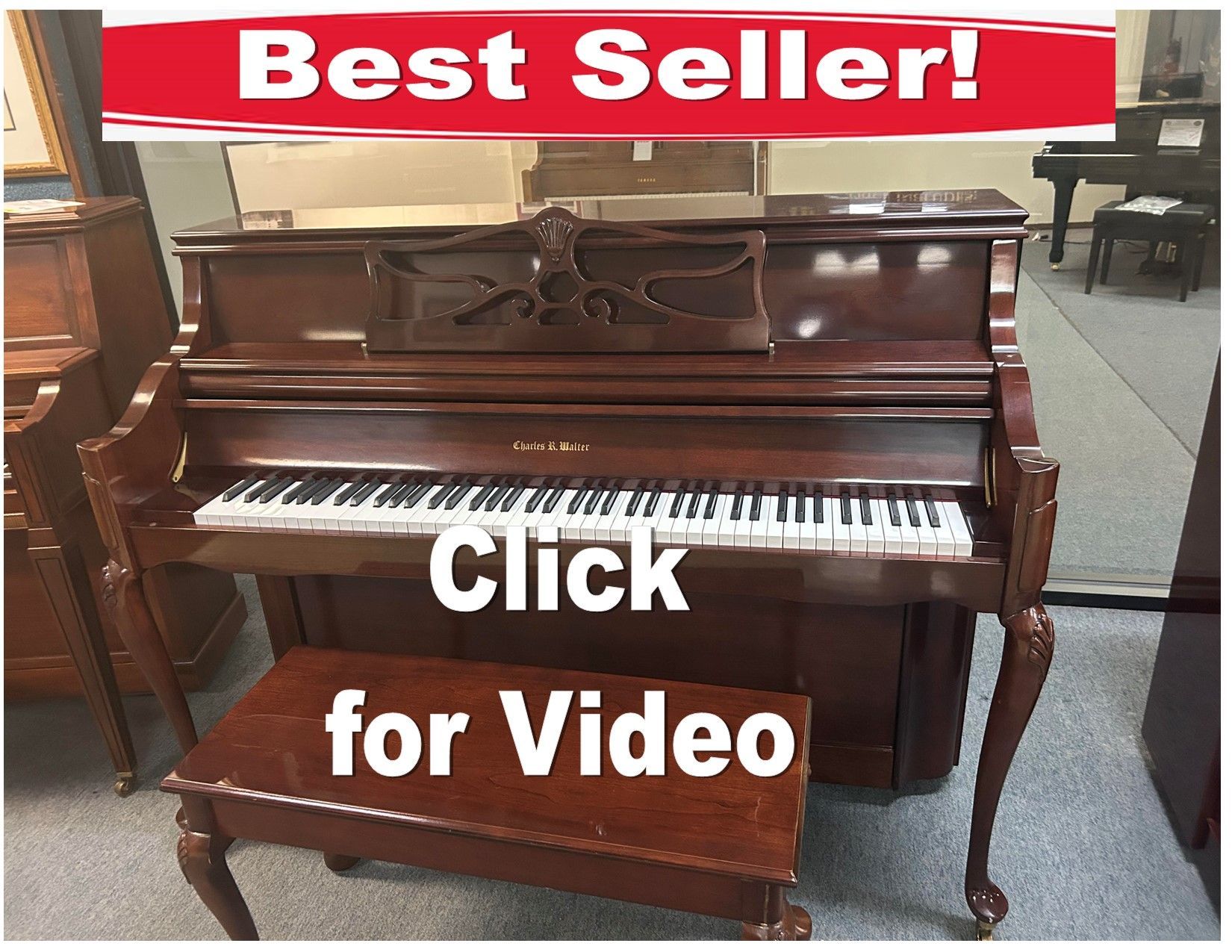 A piano is sitting in a room with the words click for video below it.