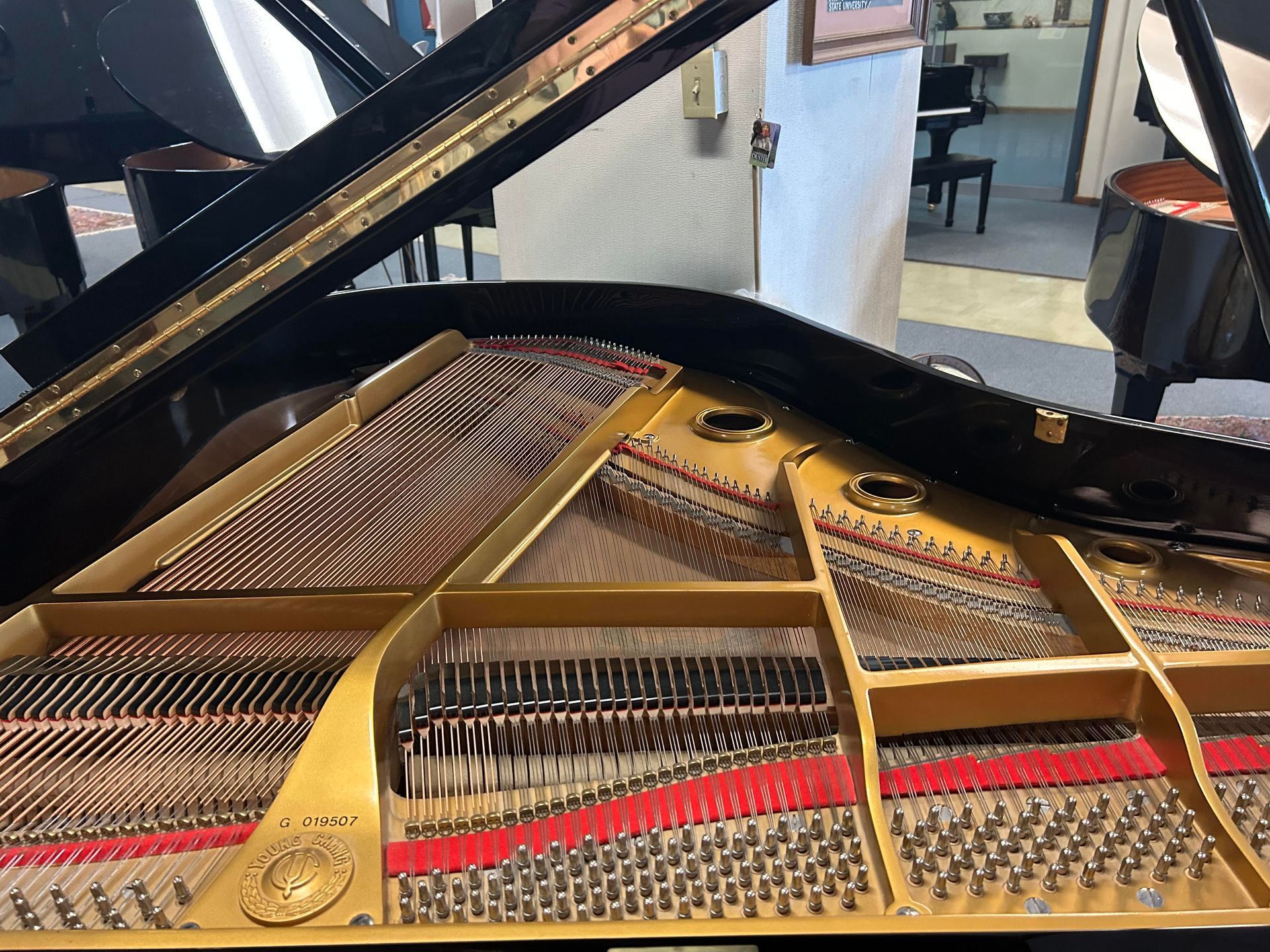 A close up of the inside of a piano with the lid open