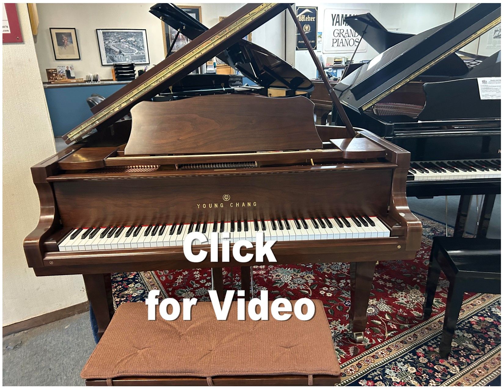 Brown grand piano in a showroom; text overlay says