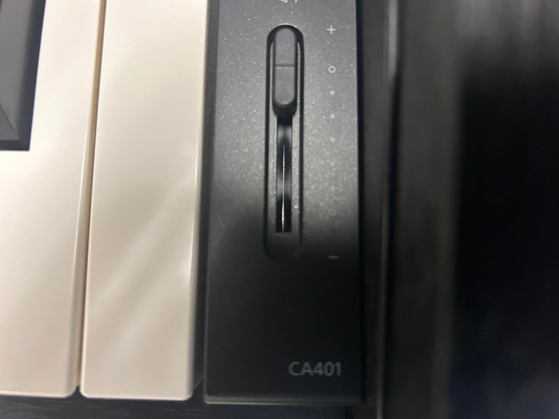 Black and white piano keys with a volume slider control