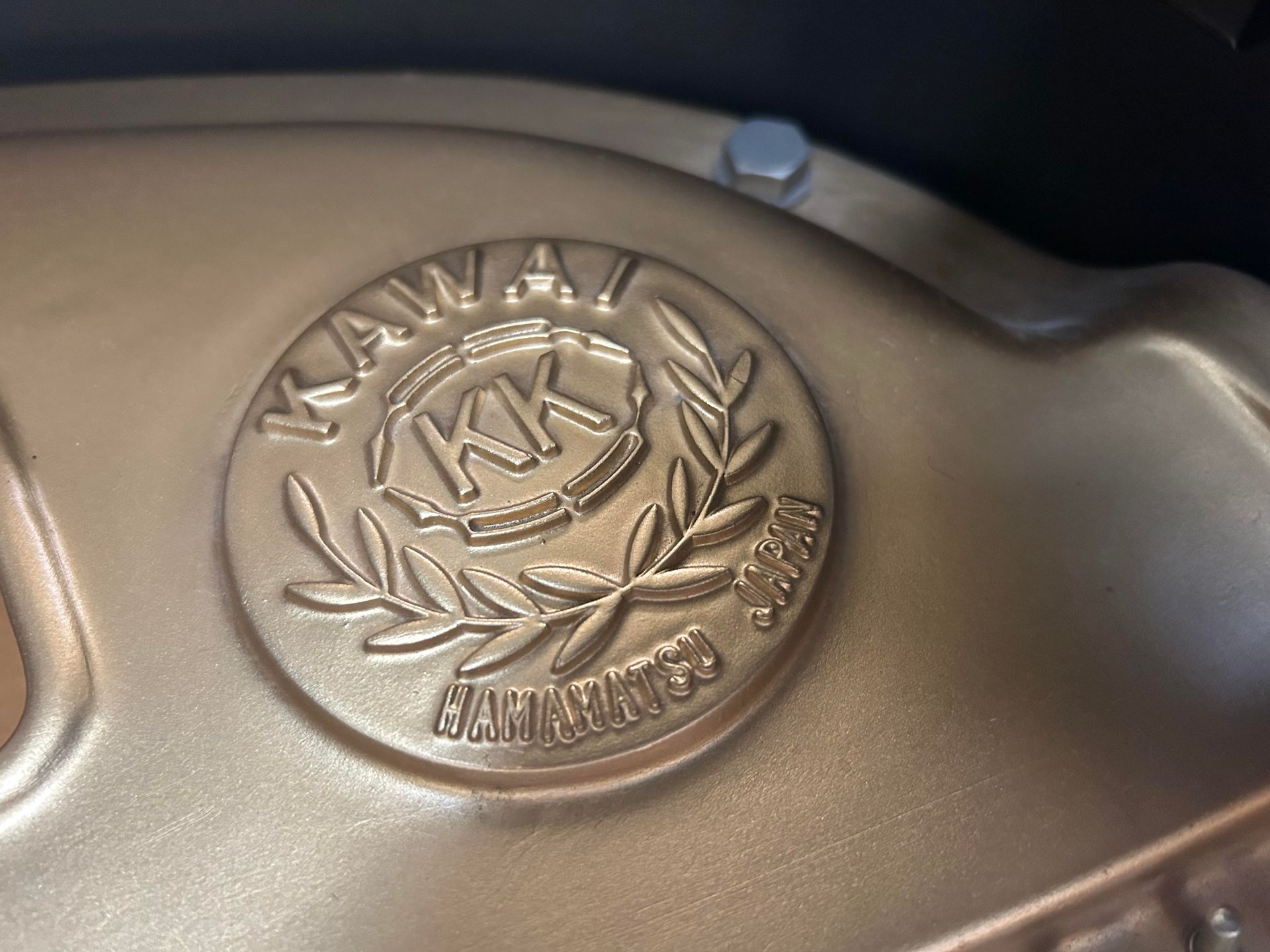 Gold emblem on a surface, reading