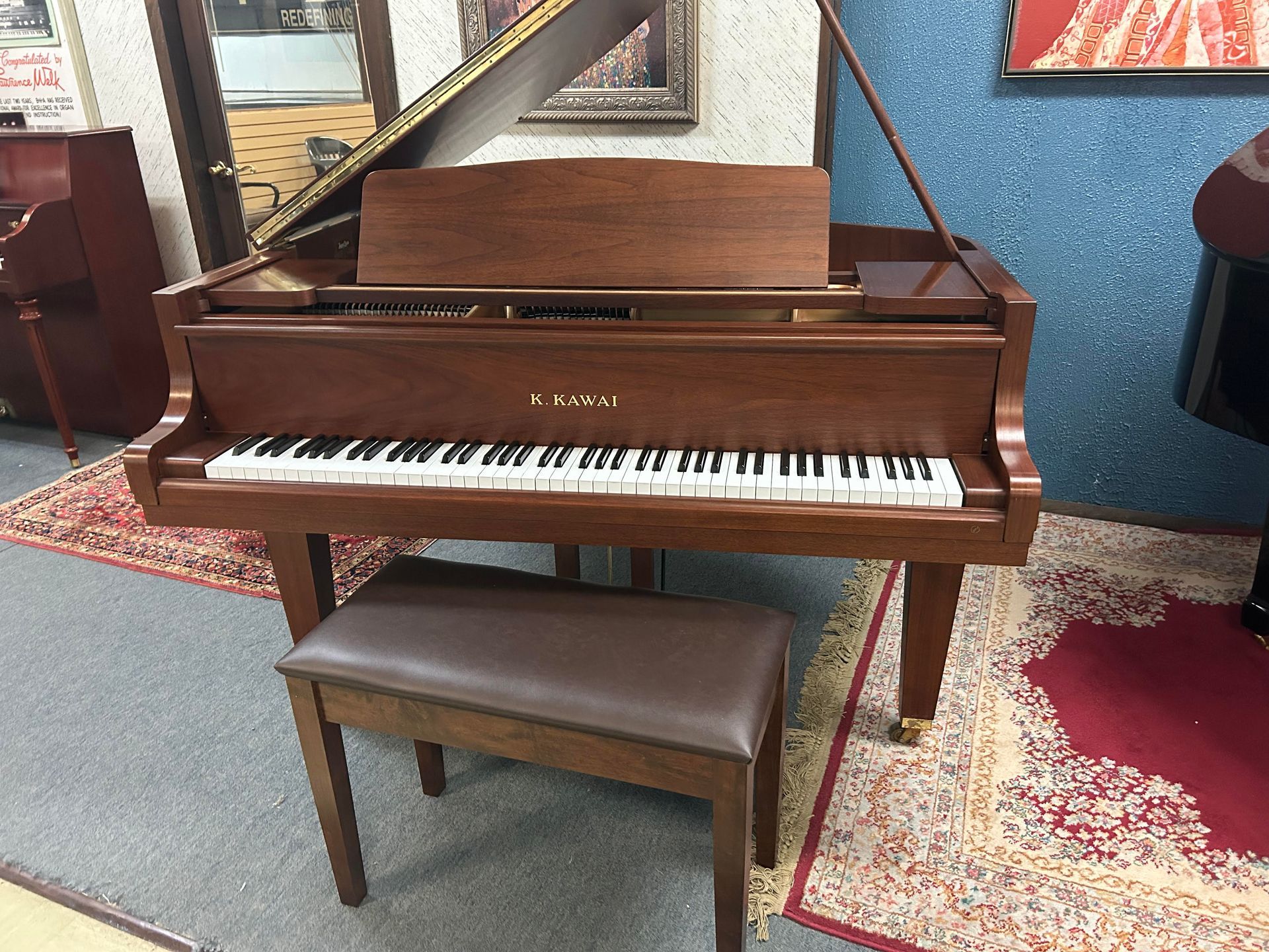A piano with a bench next to it in a room.