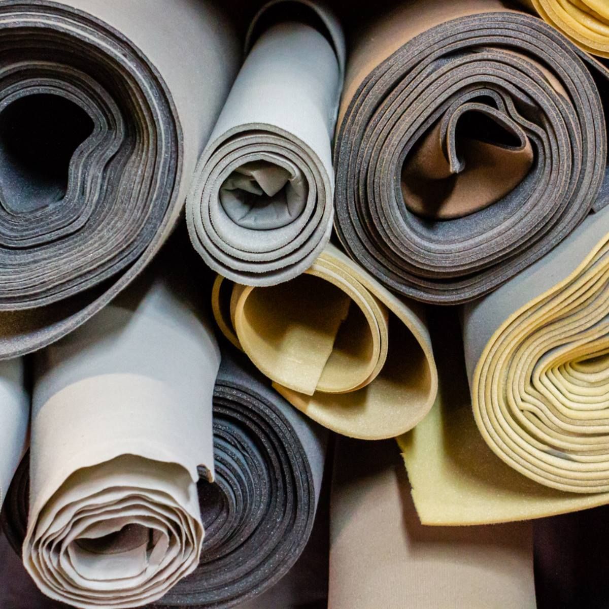 A bunch of rolls of fabric are stacked on top of each other