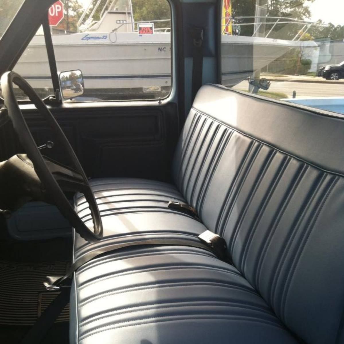 The inside of a truck with a stop sign in the background