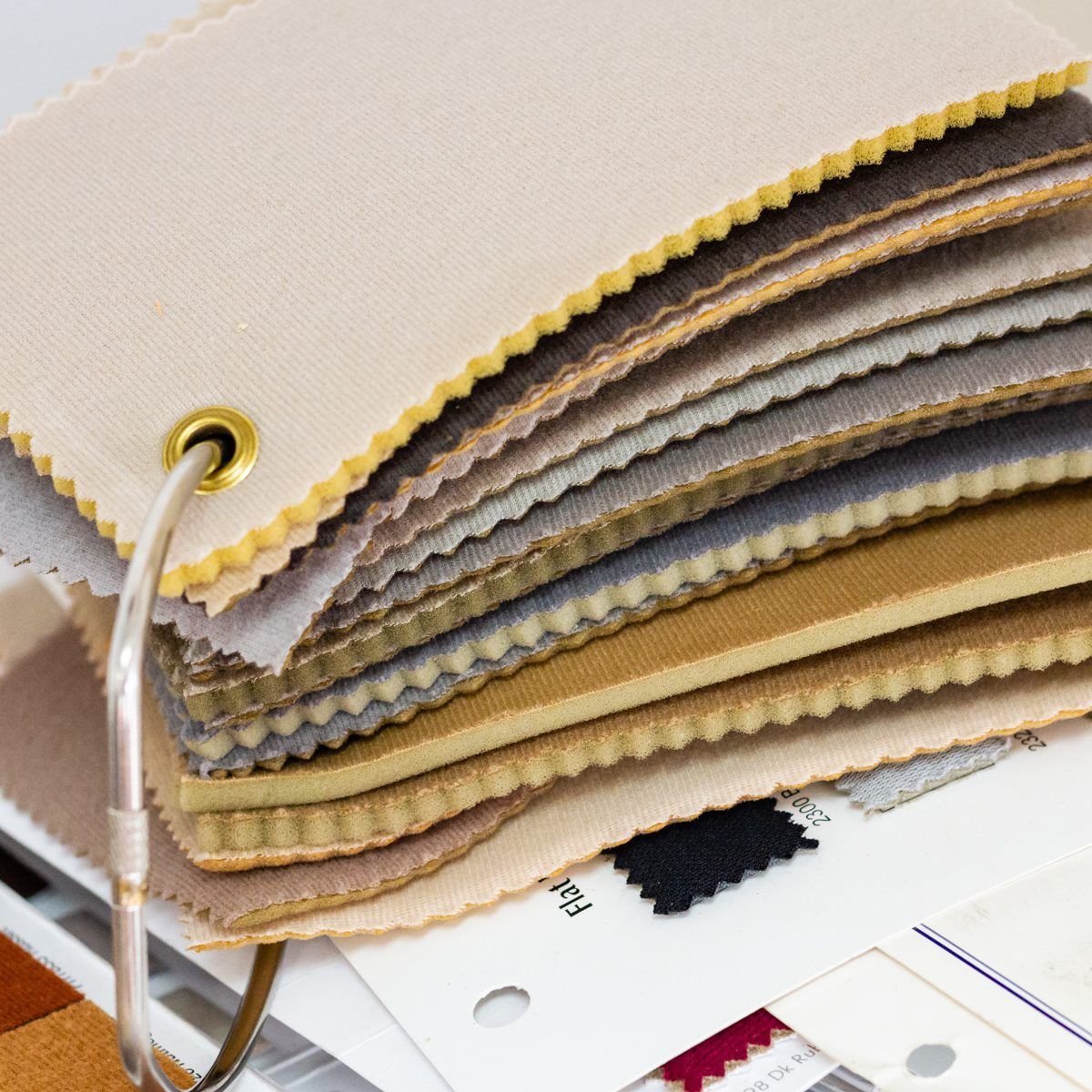 A bunch of fabric samples are stacked on top of each other